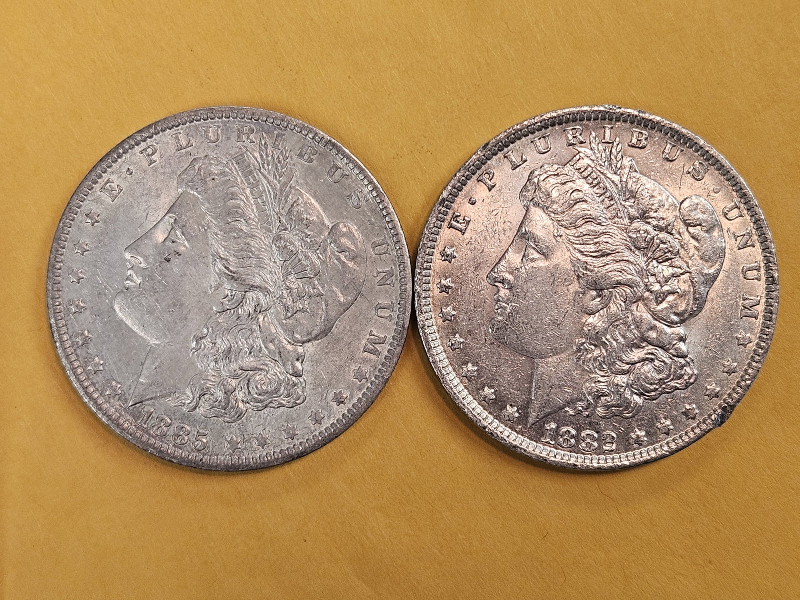 Two About Uncirculated Morgan Silver Dollars: Mixed
