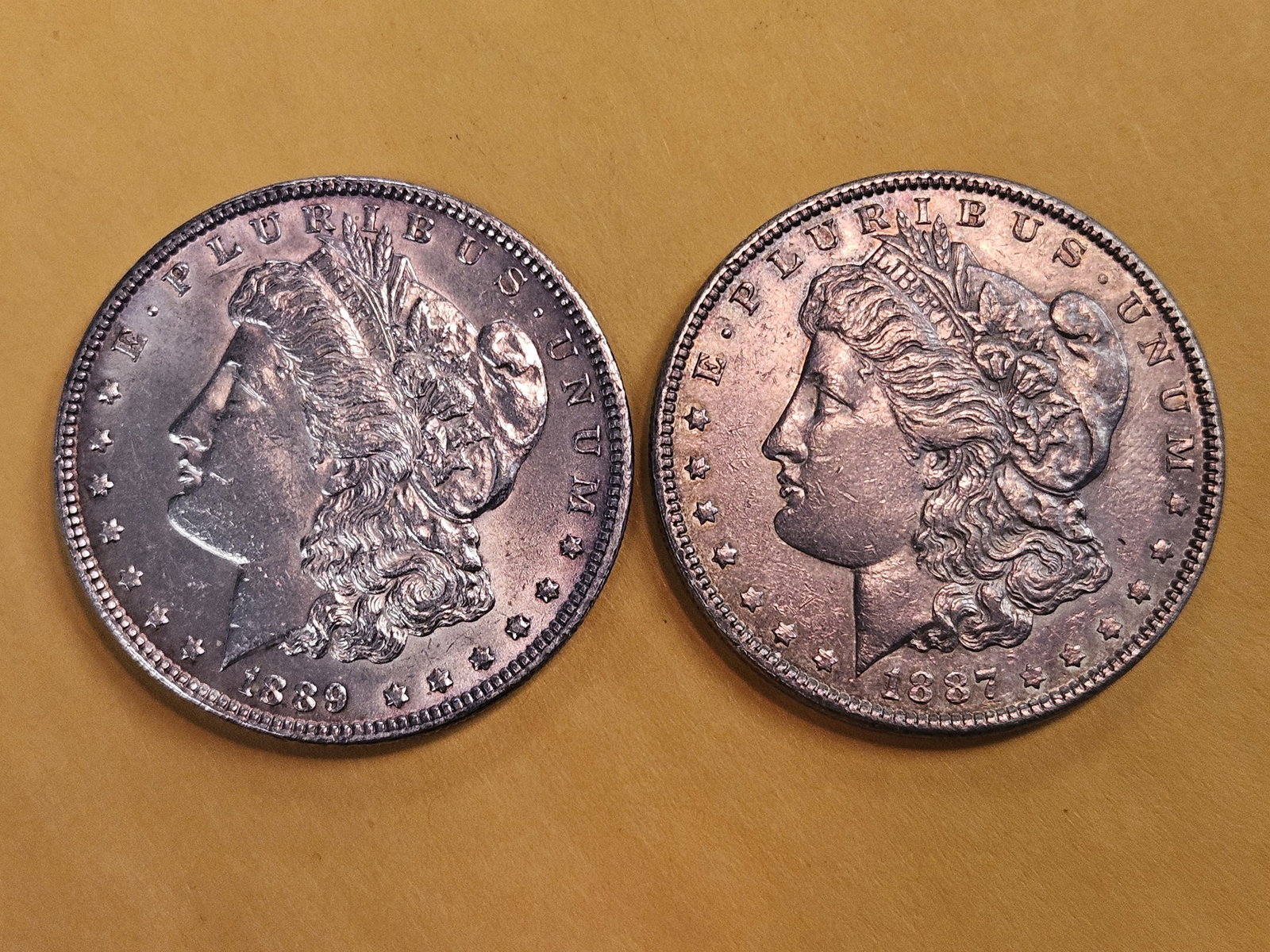 Two About Uncirculated Morgan Silver Dollars: Mixed