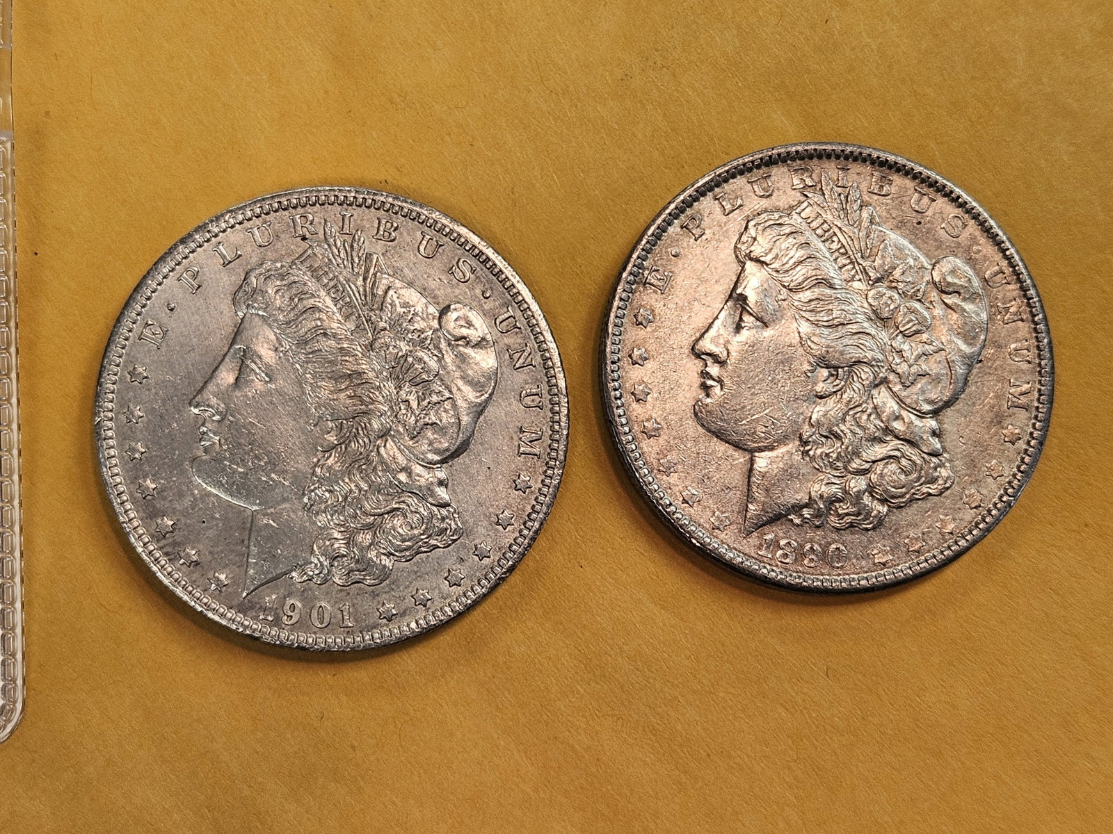 Two About Uncirculated Morgan Silver Dollars: Mixed