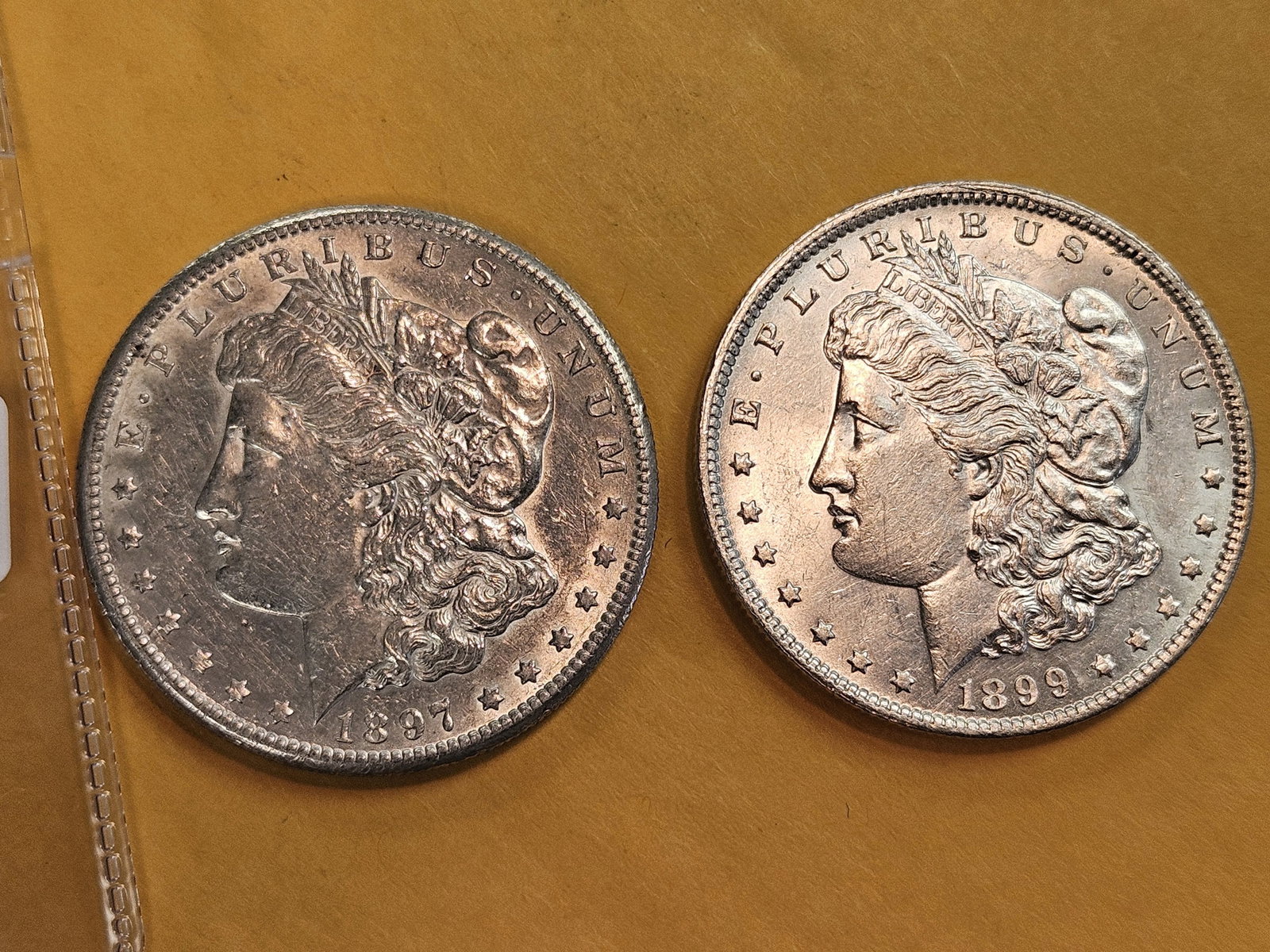 Two About Uncirculated Morgan Silver Dollars: Mixed