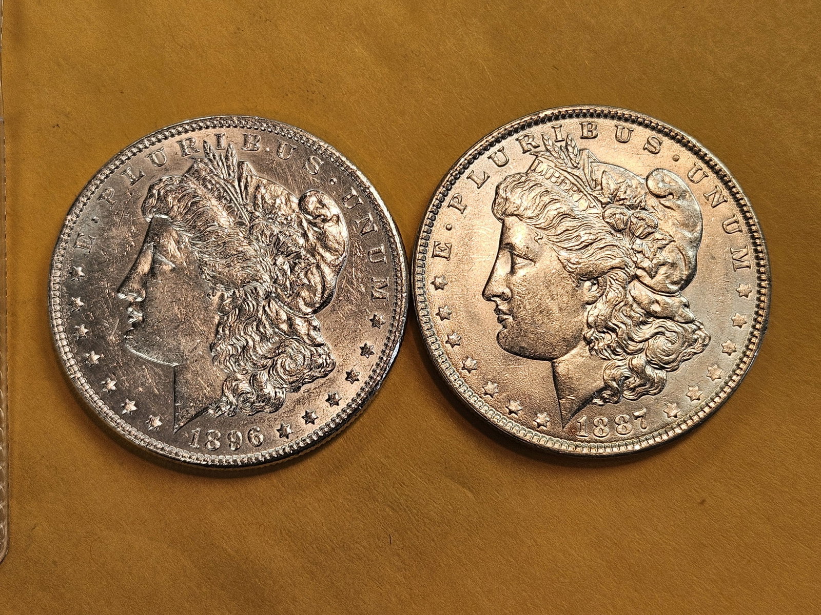 Two About Uncirculated Morgan Silver Dollars: Mixed