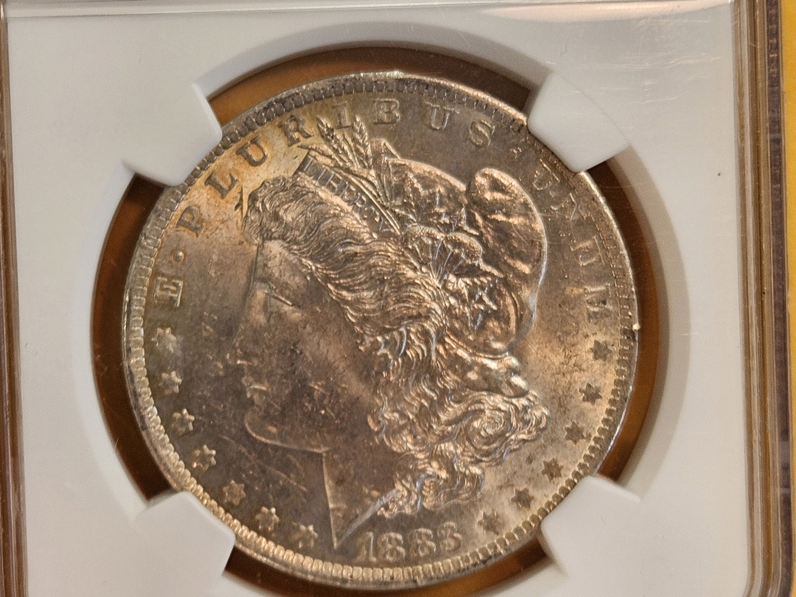 NGC 1883-O Morgan Dollar in Mint State 62: Decently toned