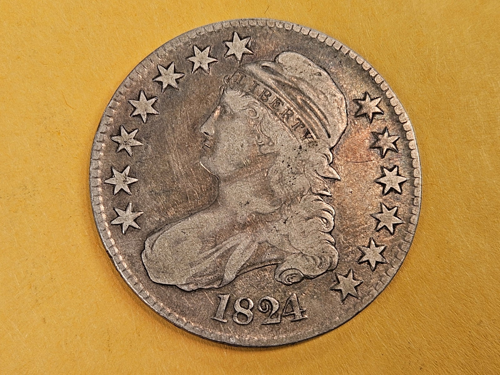 1824 Cappd Bust silver Half Dollar in Fine plus: Decent eye appeal