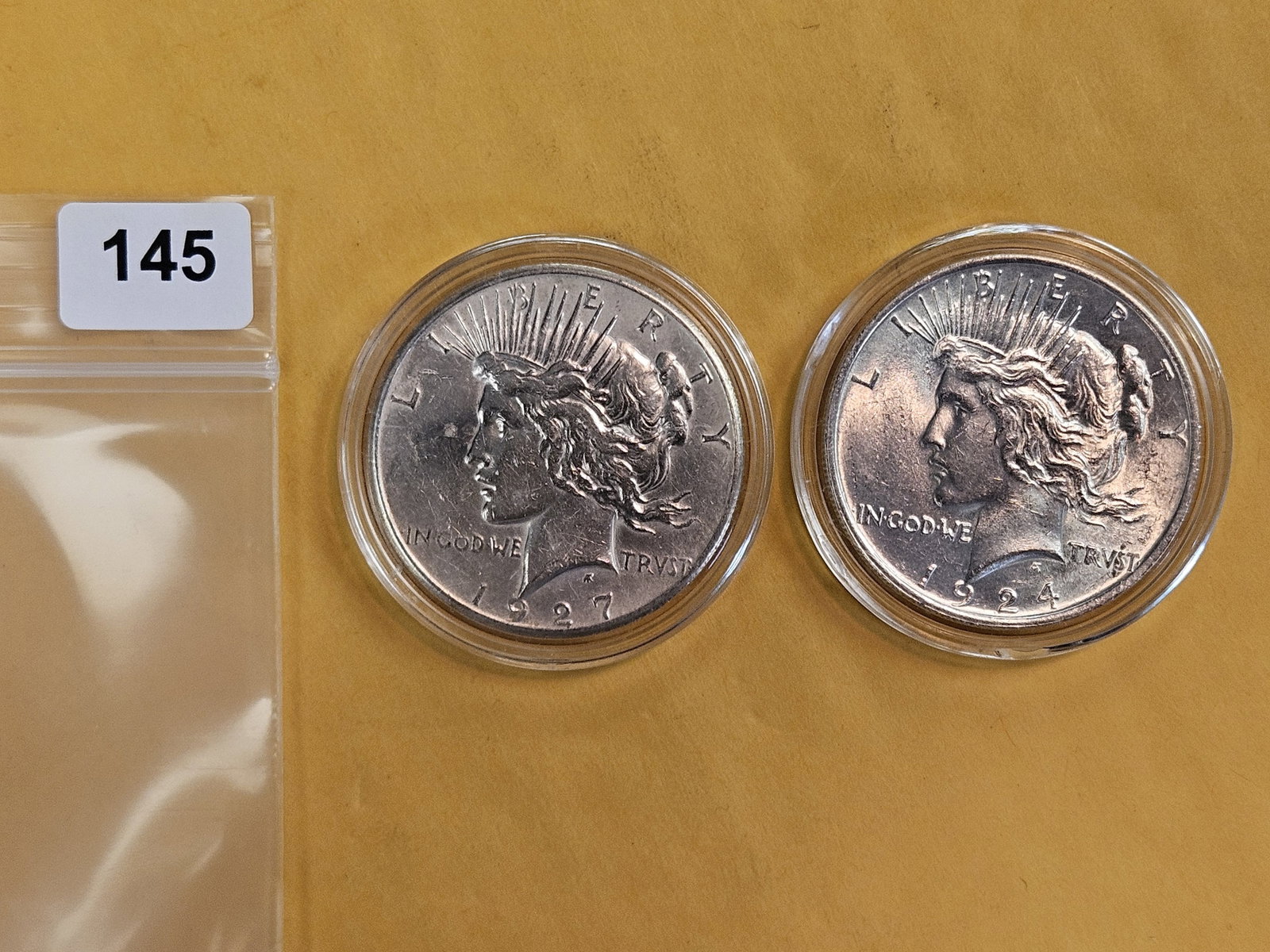 1924 and 1927 Peace Silver Dollars: Lightly circulated