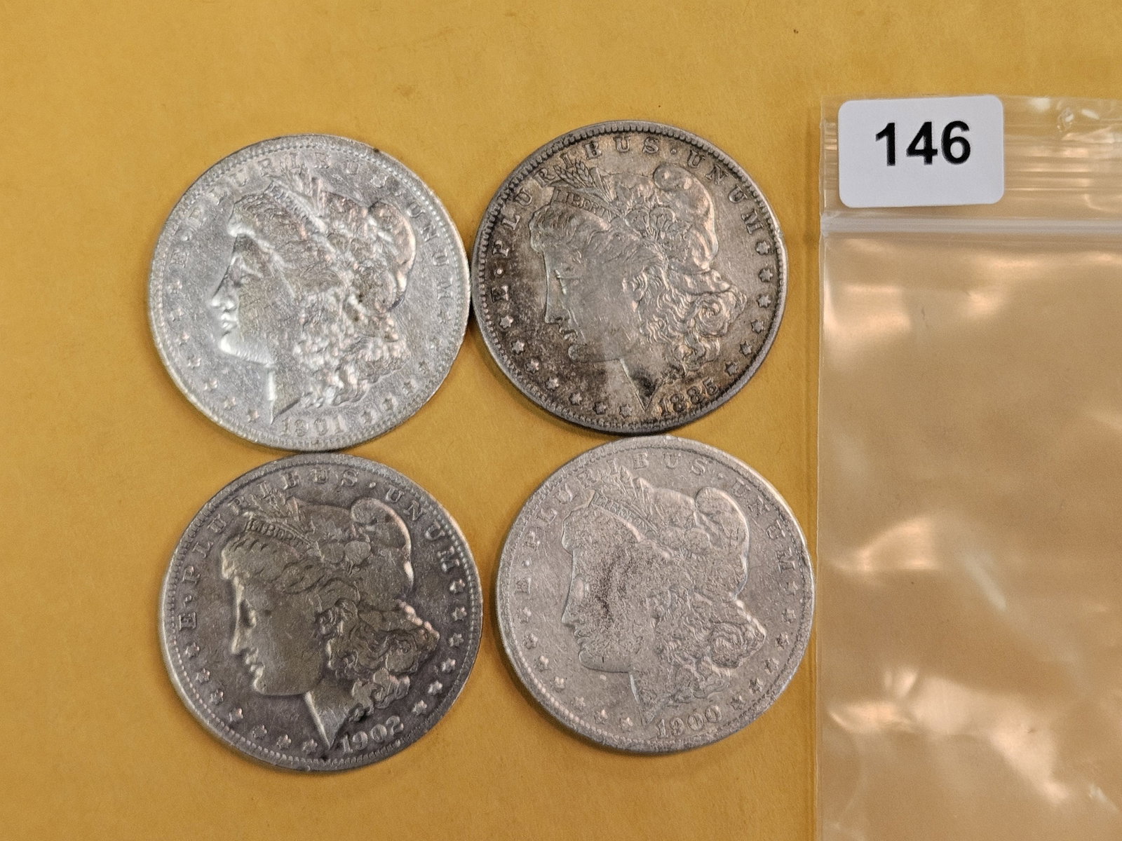 Four mixed Morgan silver Dollars: Circulated