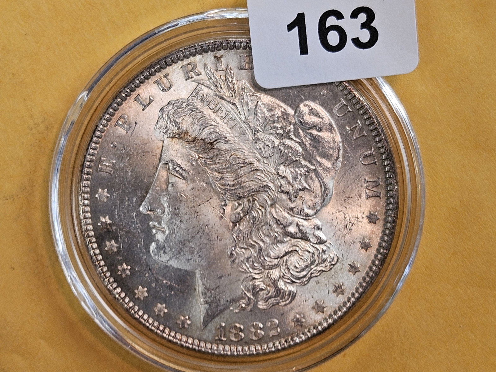 Choice Brilliant Uncirculated plus 1882 Morgan Dollar: Nice rainbow toning on the reverse