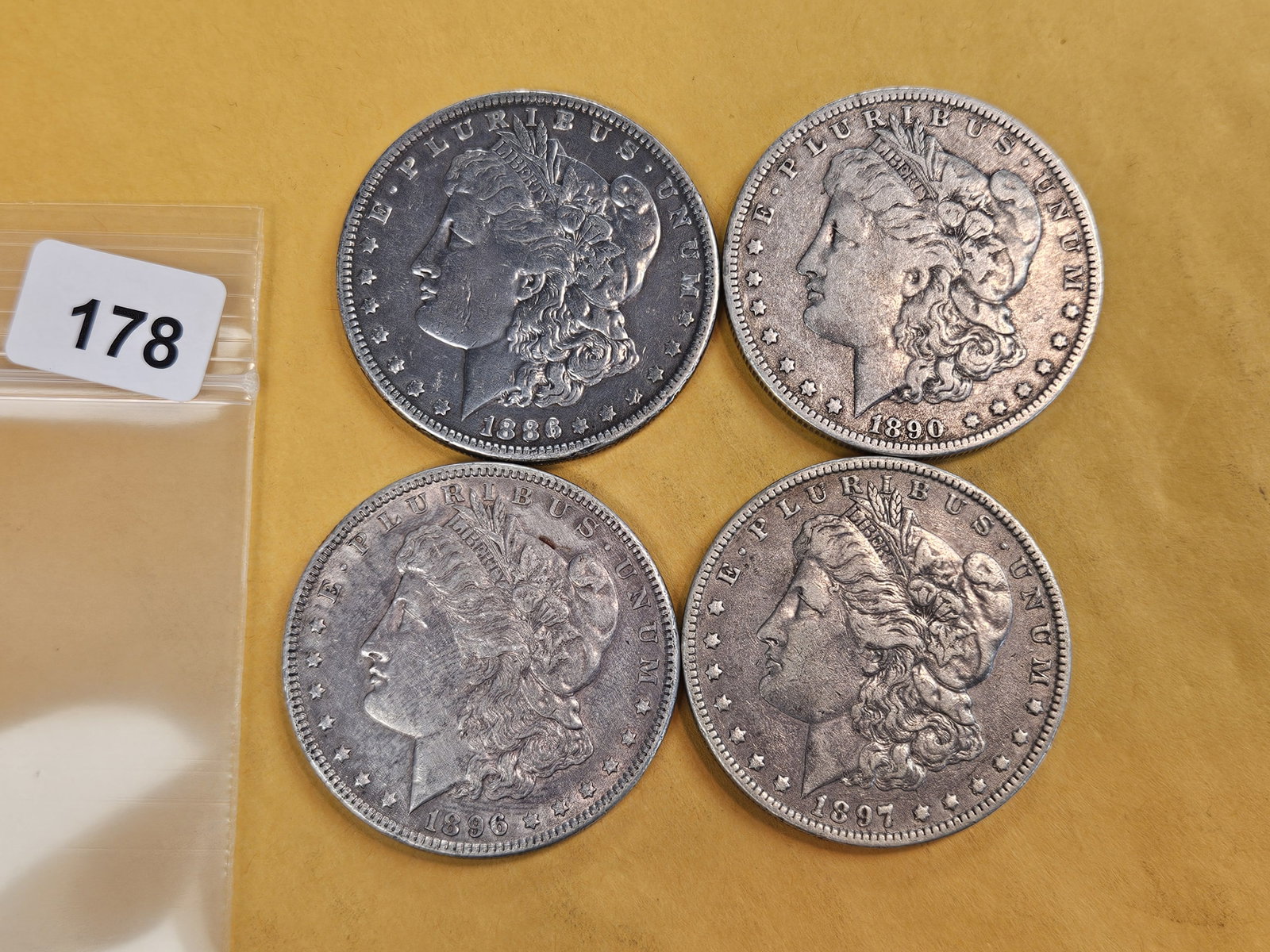 Four mixed Morgan silver Dollars: Mixed dates and grades