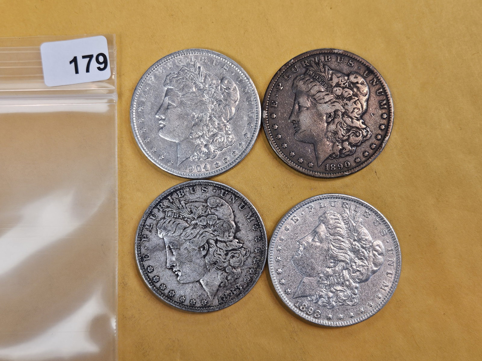 Four mixed Morgan silver Dollars: Mixed dates and grades