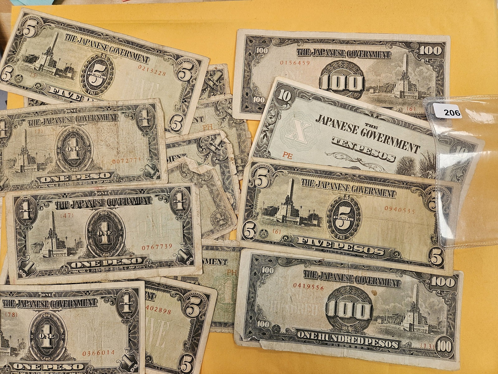 Mix of about Fifteen Japanese Government pieces of currency: One, Five, ten and 100 pesos