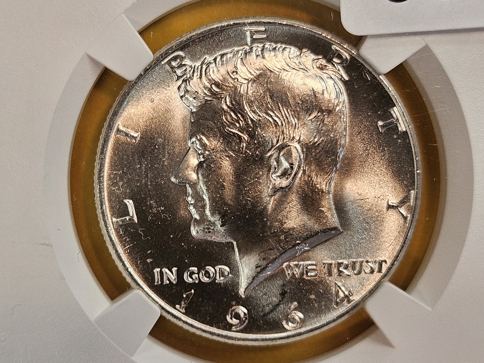 NGC 1964 silver Kennedy Half Dollar in Mint State 64: Ultra Breaks label