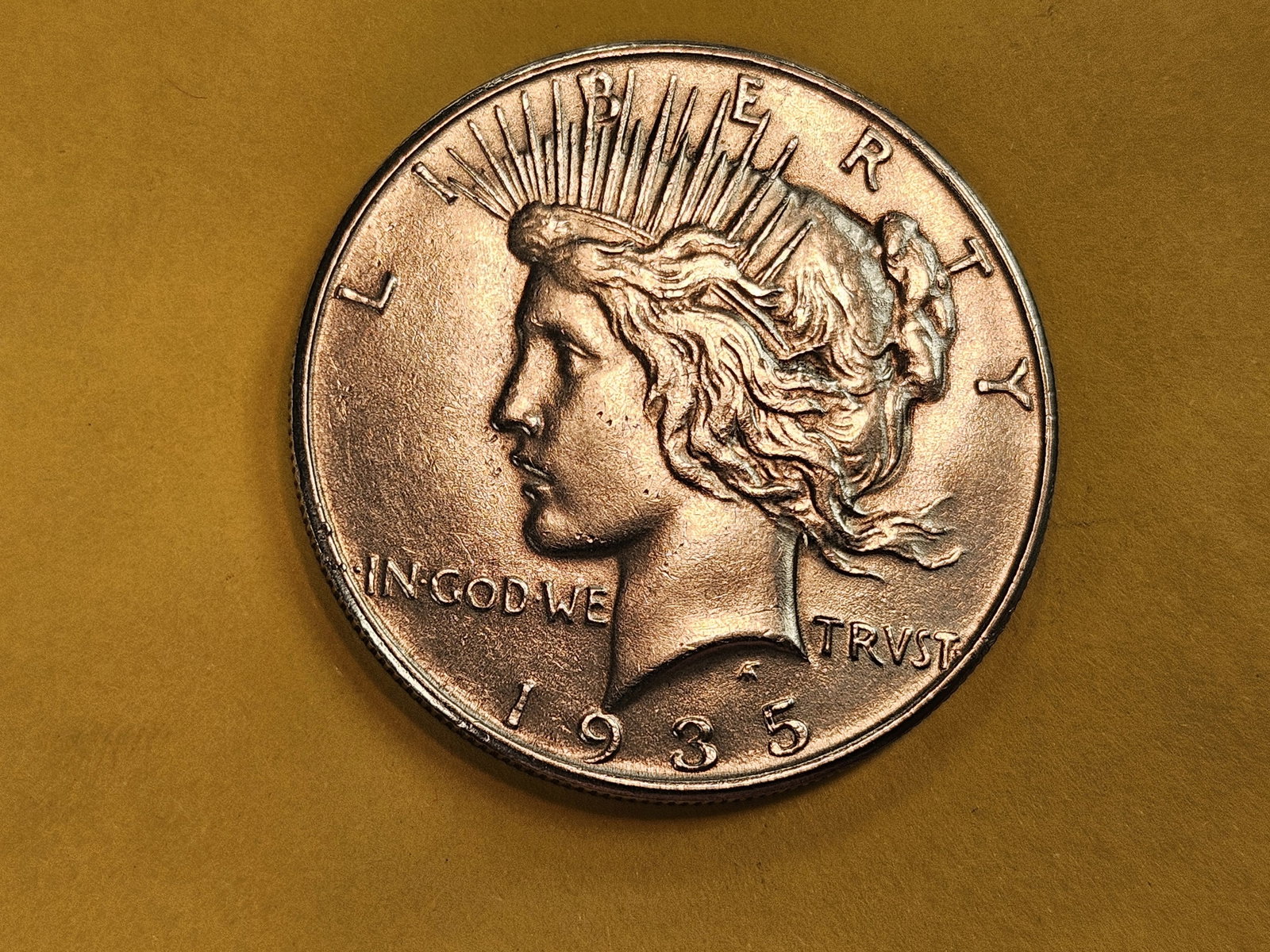 1935 Peace silver Dollar in About Uncirculated plus: Good cartwheel