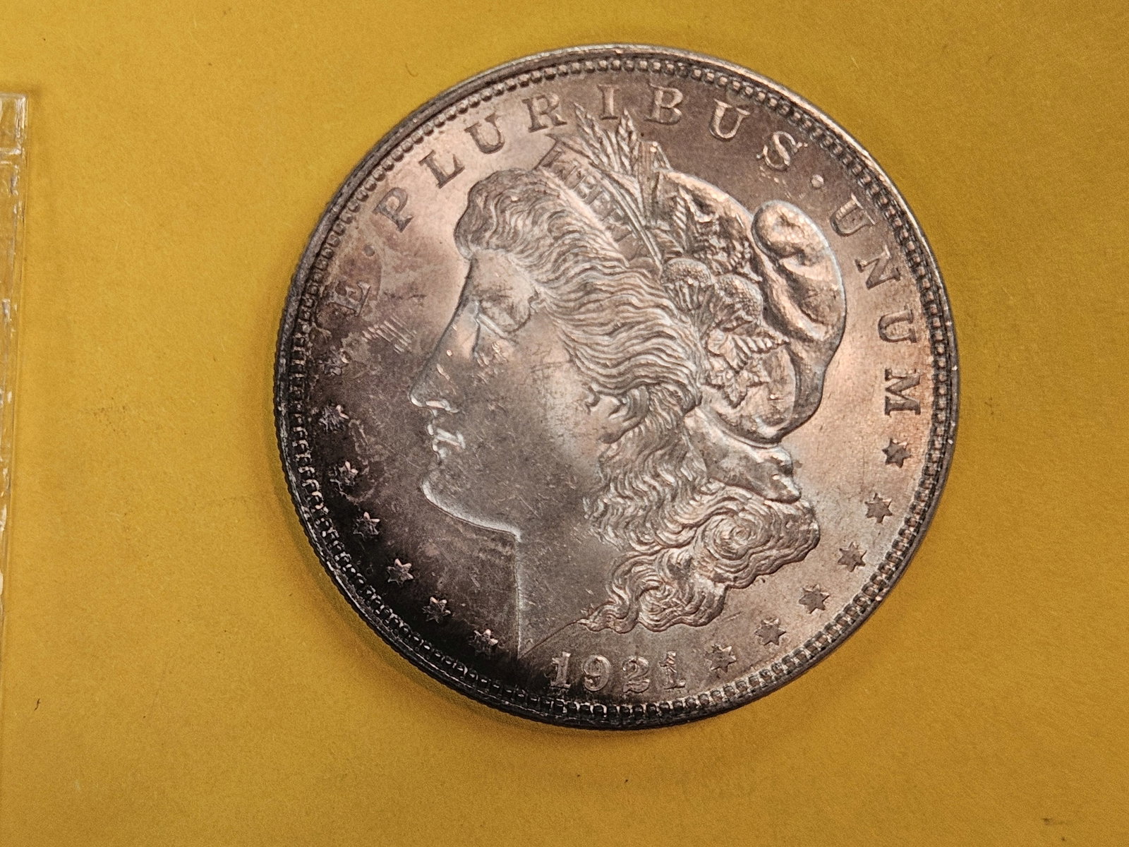 Very Choice to GEM Brilliant Uncirculated 1921 Morgan Dollar: Starting a nice crescent bit of toning