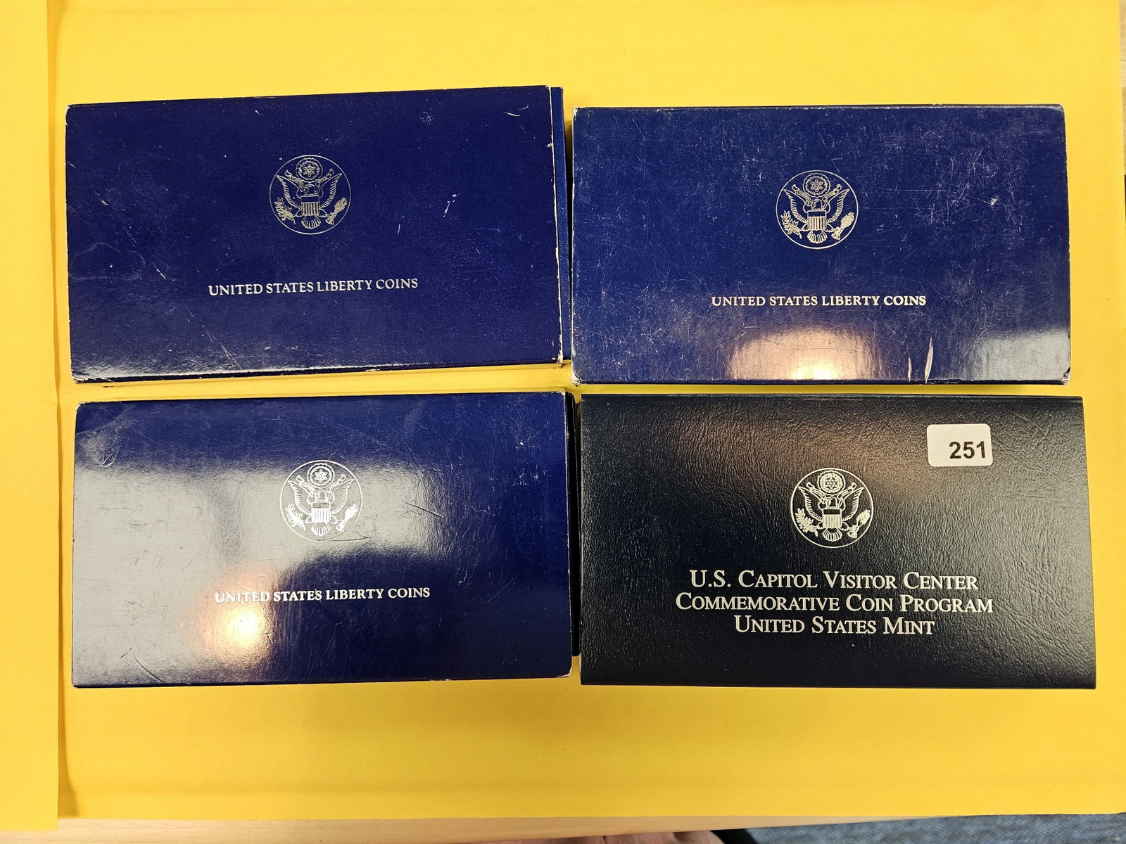 Four mixed US Coin Sets: In OGP. Includes three Silver Dollars