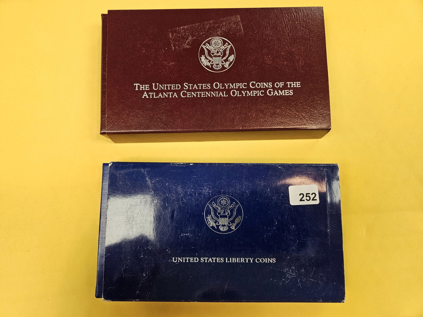 Two US Coin sets: In OGP. Includes Two Silver Dollars