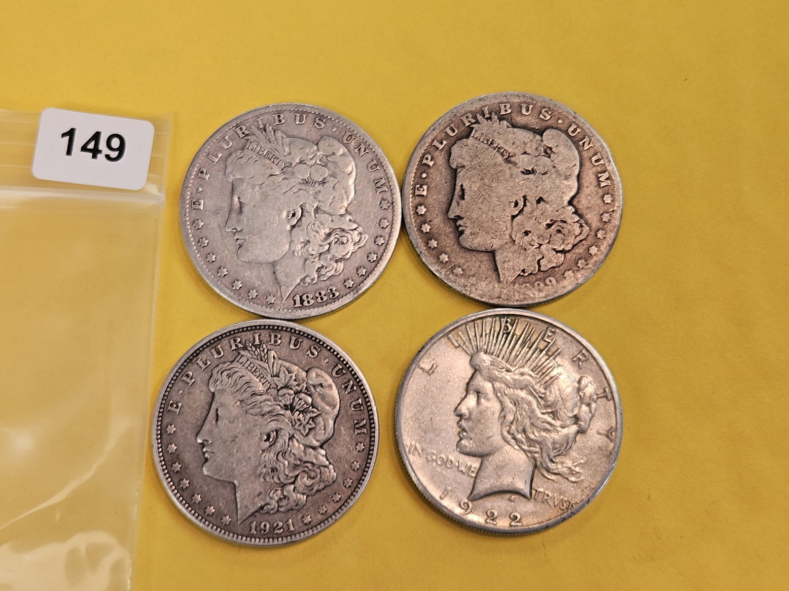Four mixed Morgan and Peace silver Dollars: Circulated