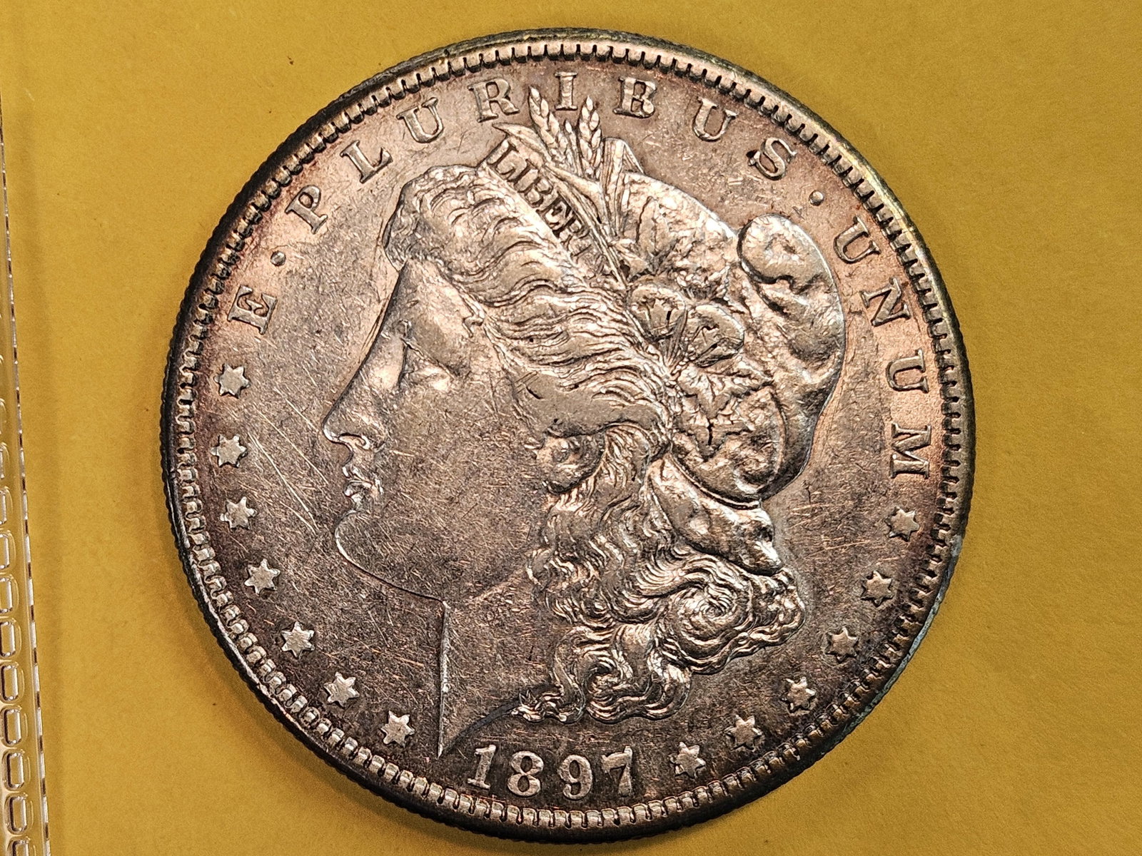 1897-S Morgan Dollar in Brilliant About Uncirculated plus: Light purplish patina