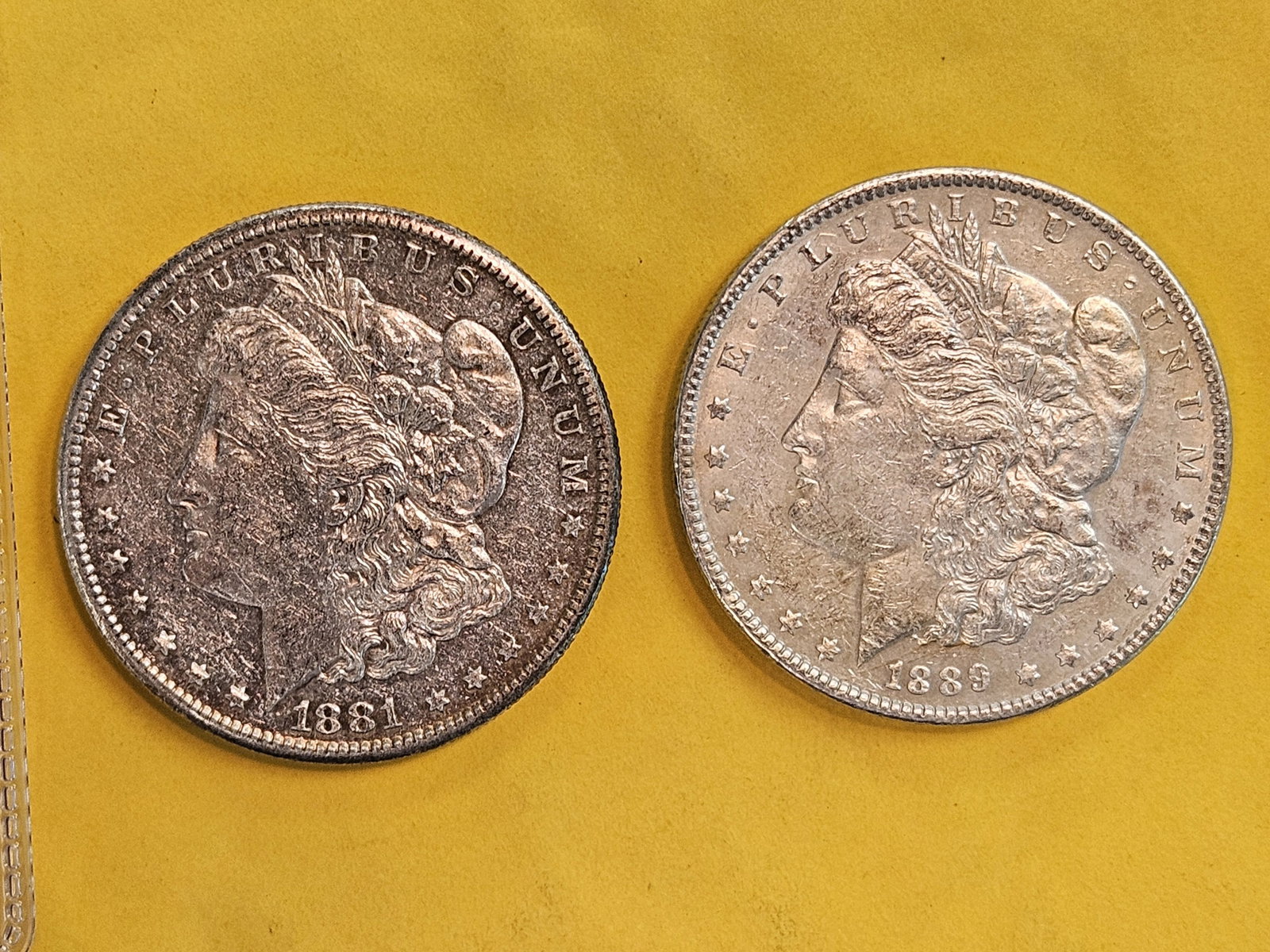 Two About Uncirculated plus Morgan silver Dollars: 1881-S and 1889