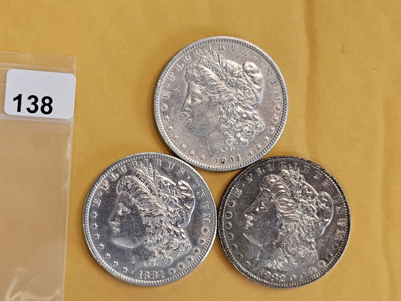 Three mixed Morgan Silver Dollars: All in About Uncirculated
