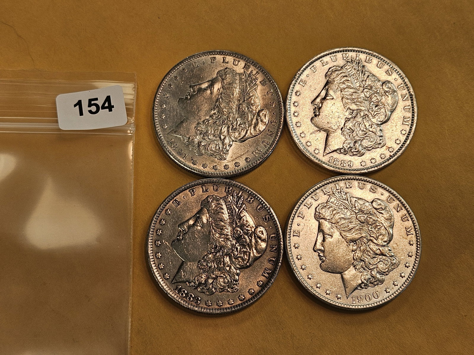 Four mixed Morgan Silver Dollars - 2