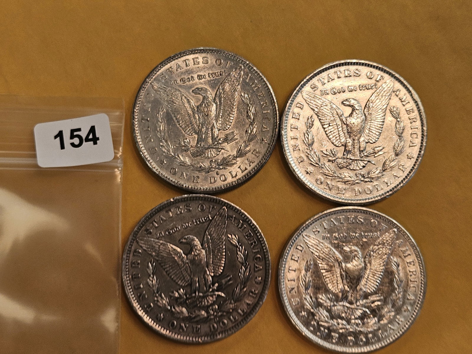 Four mixed Morgan Silver Dollars - 3