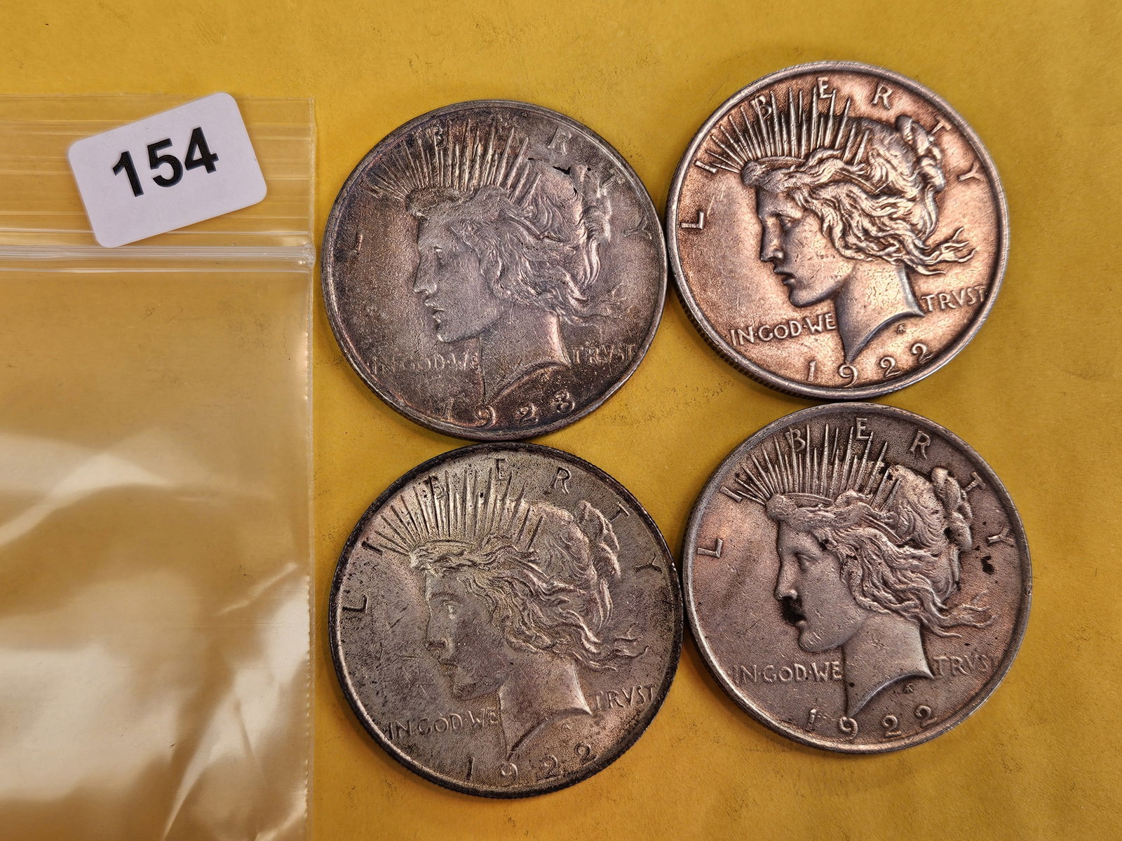 Four mixed Peace Silver Dollars: Circulated