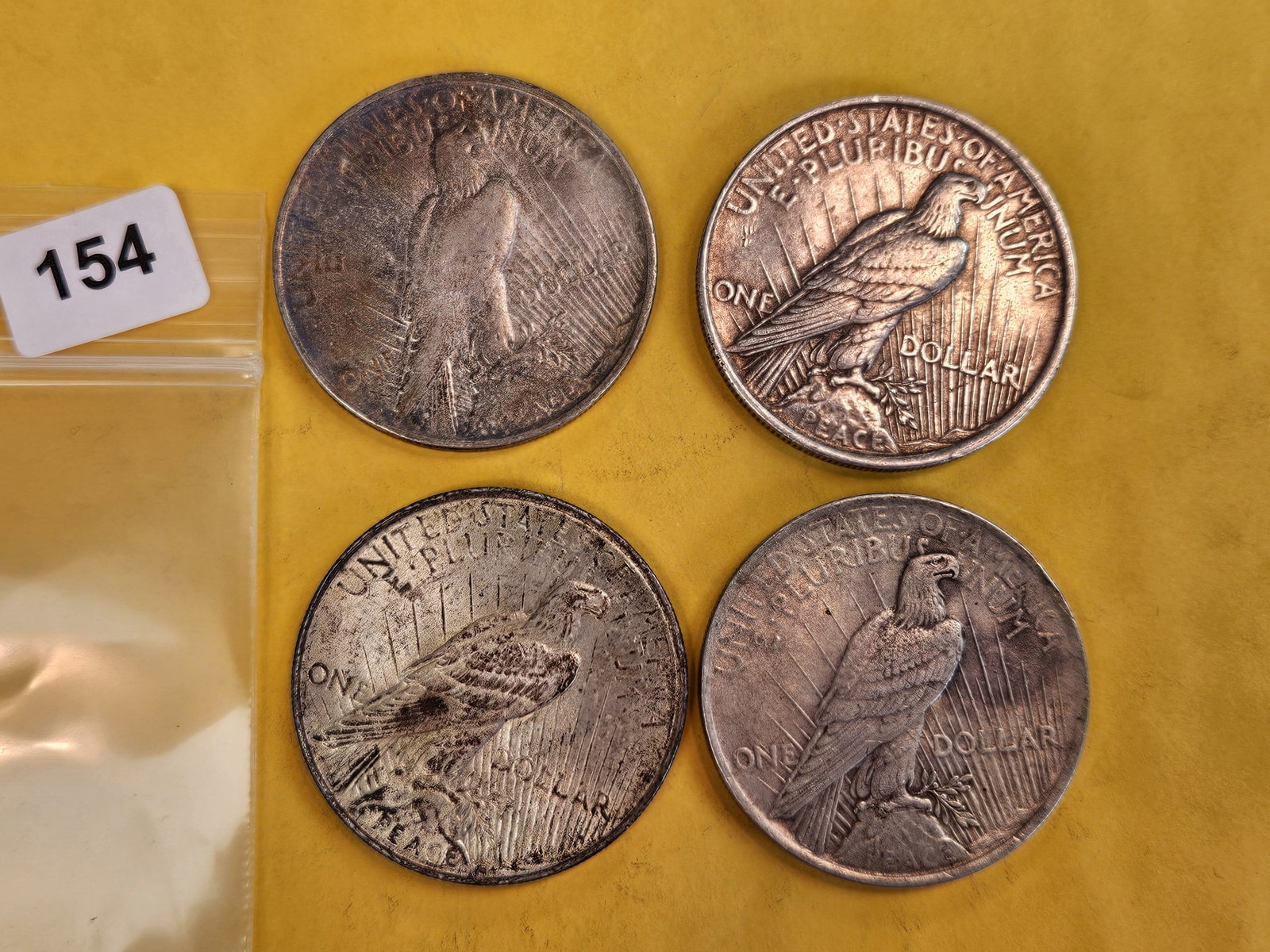 Four mixed Peace Silver Dollars - 2