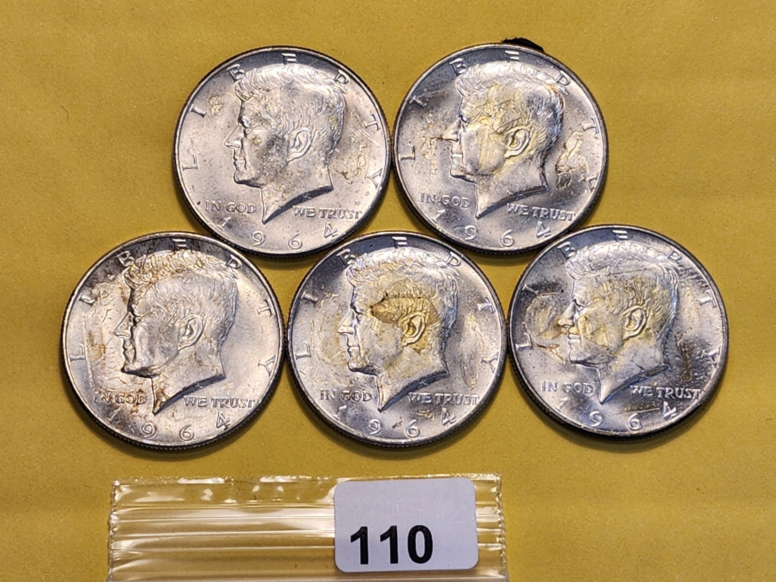 Five Kennedy Silver Half Dollars: All 1964. Has glue residue and paper