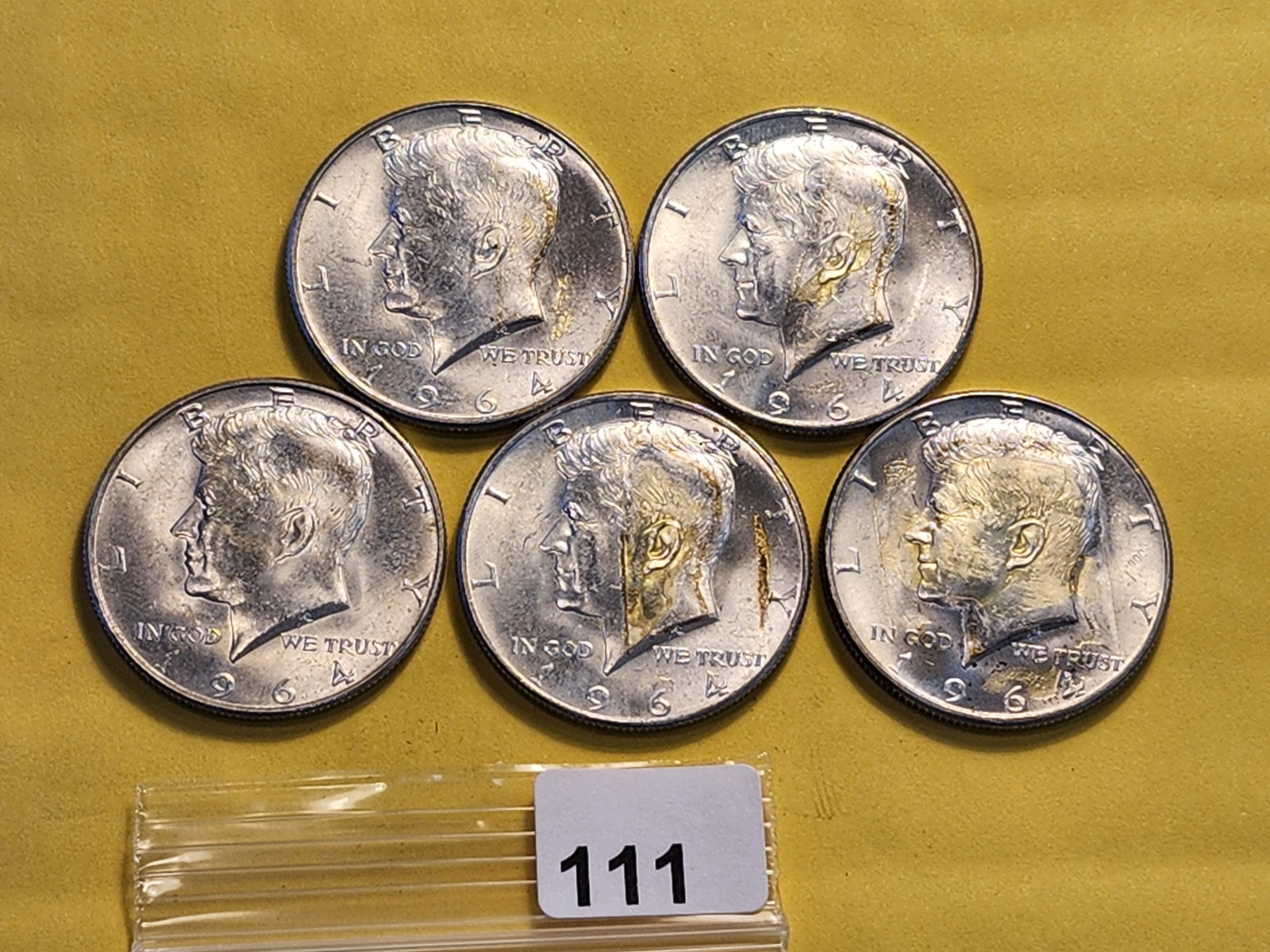 Five Kennedy Silver Half Dollars: All 1964. Has glue residue and paper
