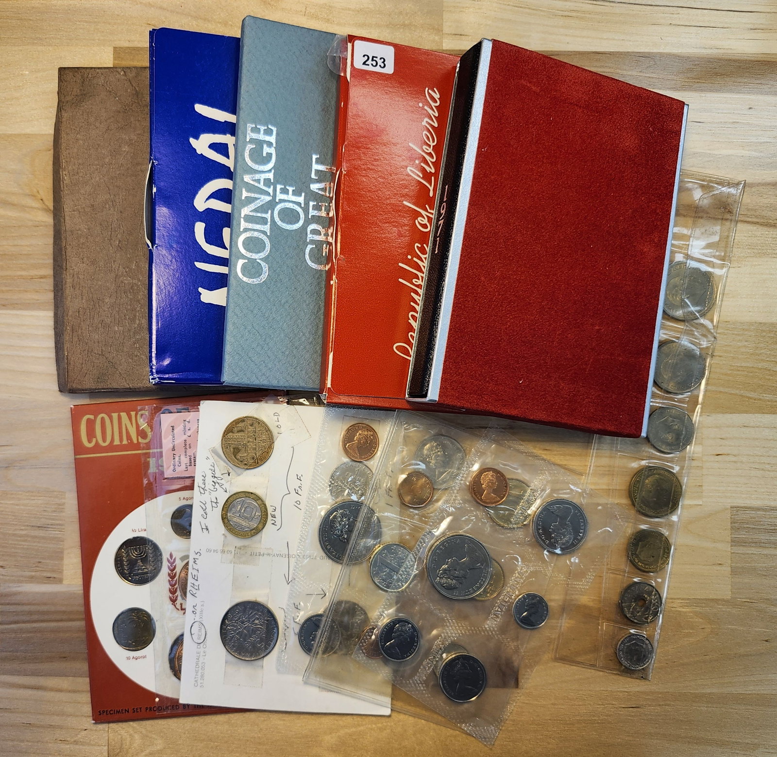 Twelve Assorted World Coins Sets: Most in original government packaging. Countries include Canada, Nepal, Liberia, Israel and more!