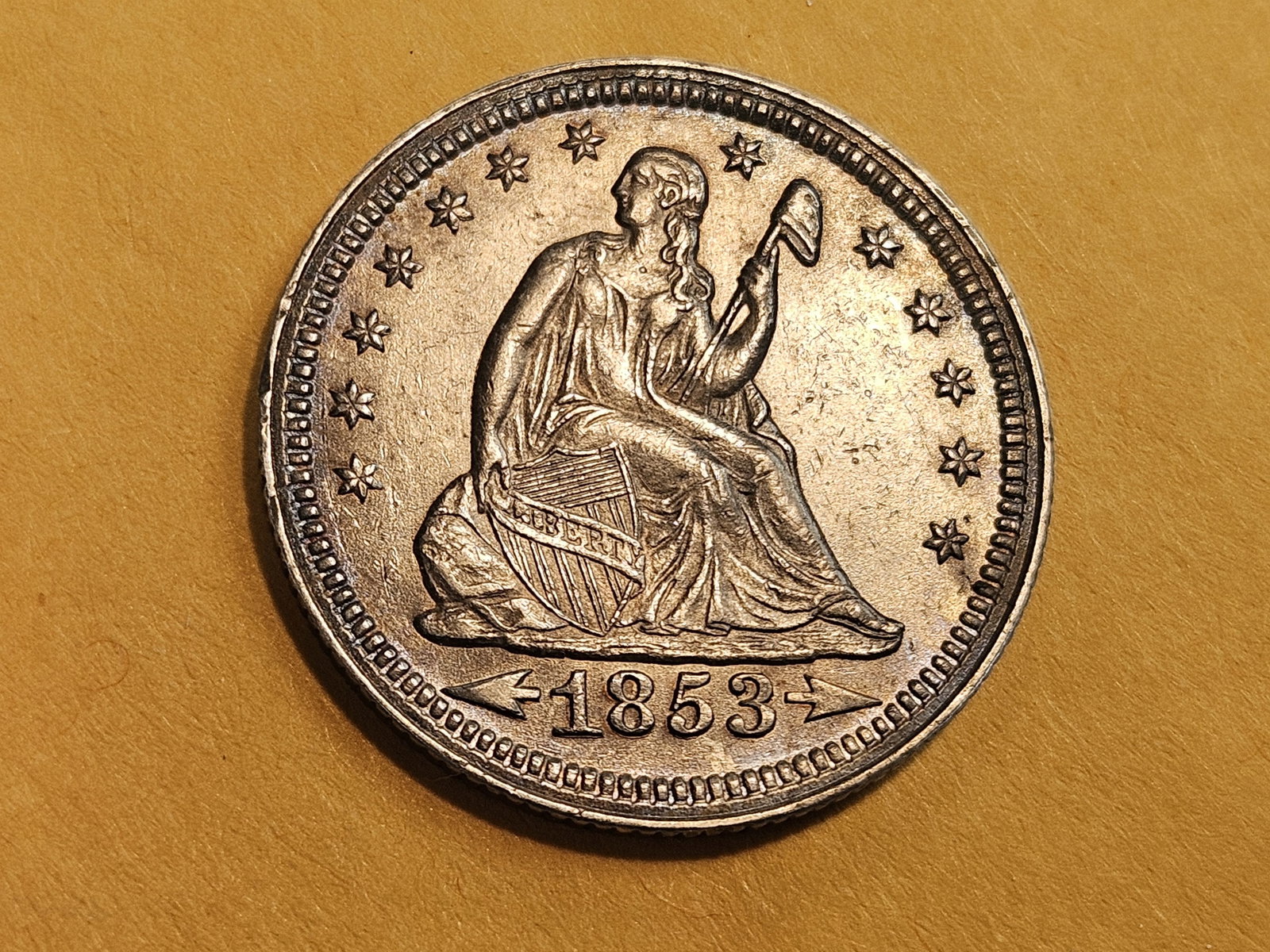 ** Choice Uncirculated 1853 With Arrows Seated Liberty Quarter: Amazing eye appeal! Strong luster underneath a fantastic bit of patina!