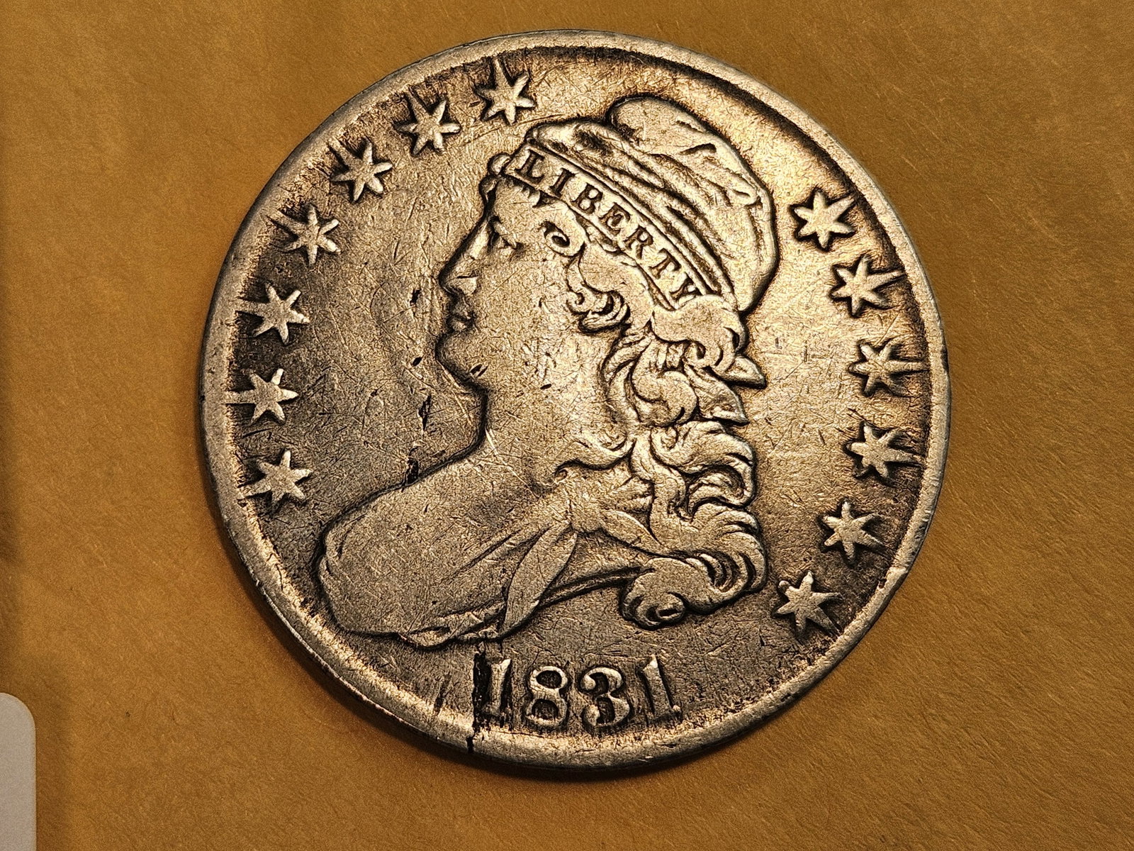 1831 Capped Bust Half Dollar in Very Fine - details: Small lamination error by the date