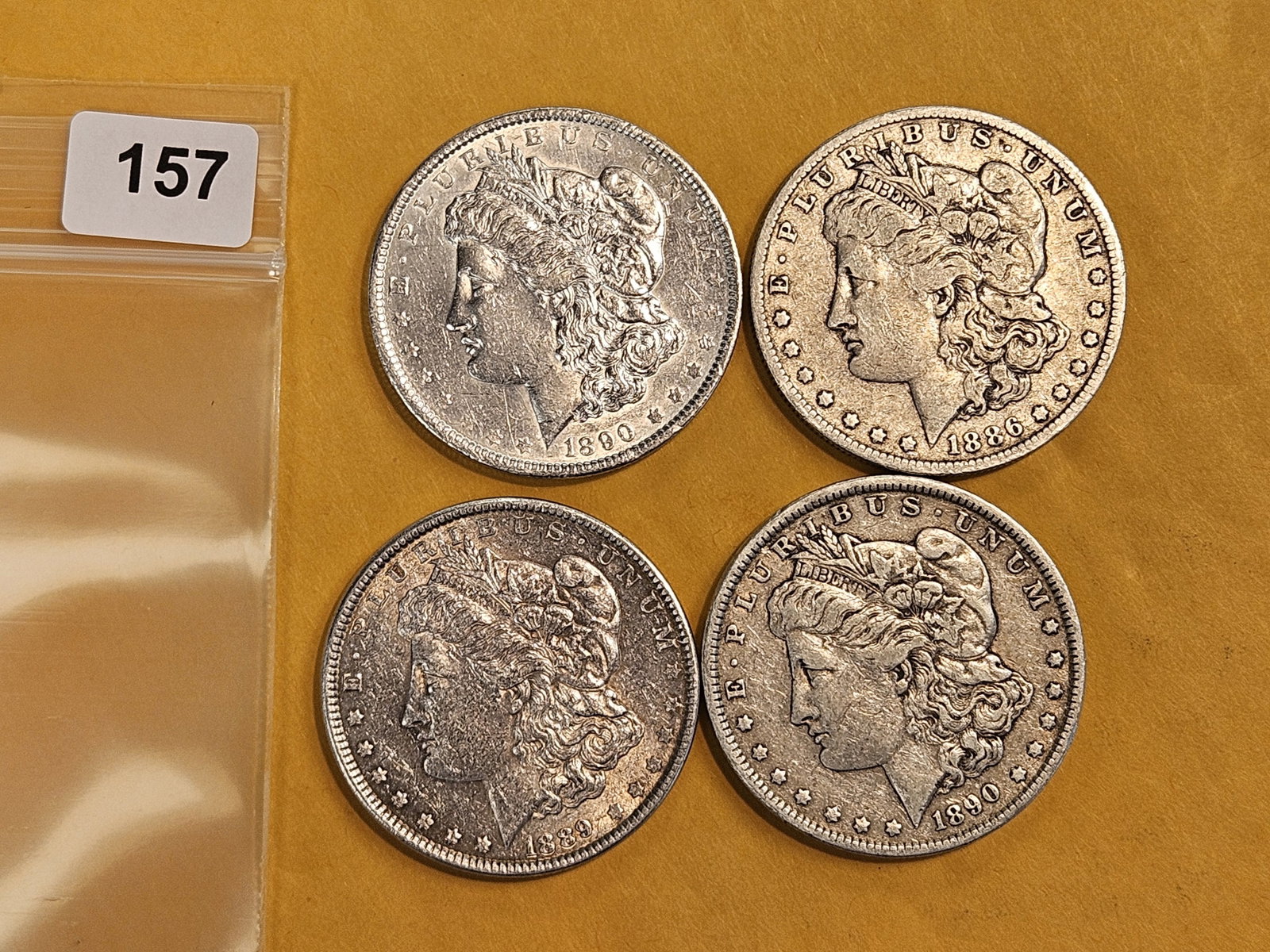 Four mixed Morgan silver Dollars: Mixed dates and grades