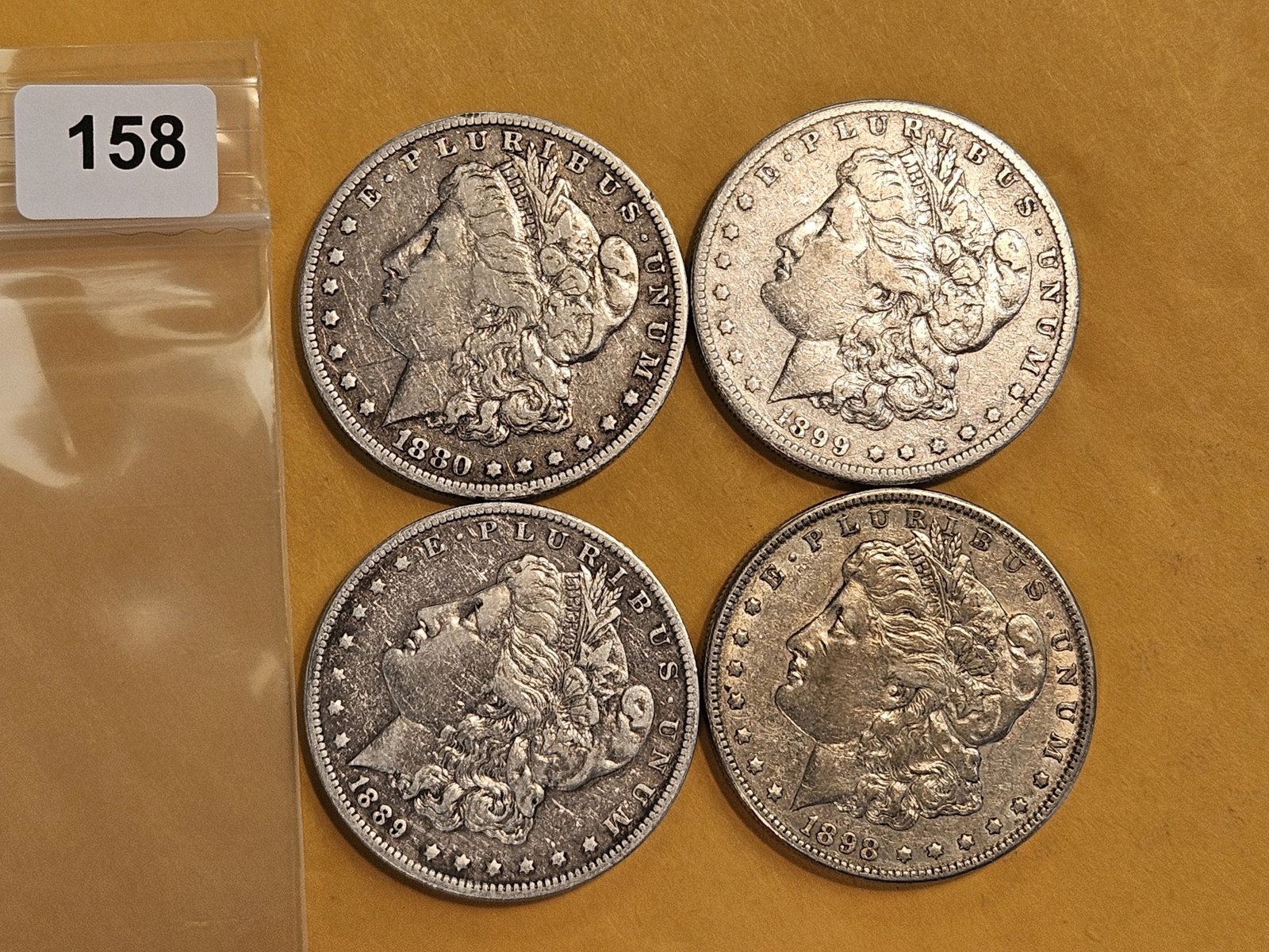 Four mixed Morgan silver Dollars: Mixed dates and grades