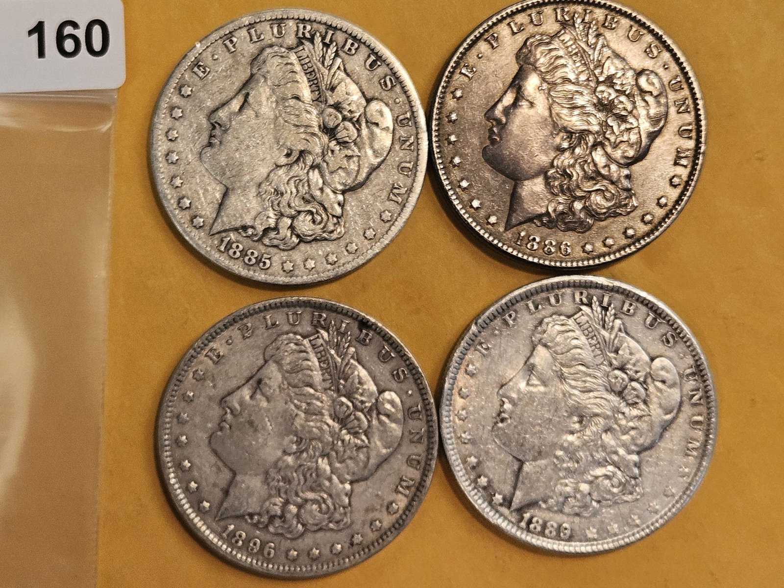 Four mixed Morgan silver Dollars: Mixed dates and grades