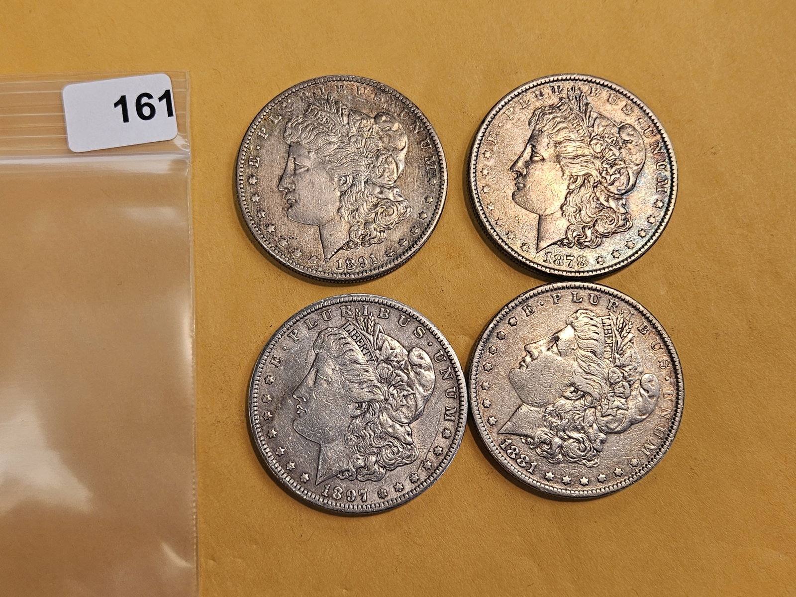 Four mixed Morgan silver Dollars: Mixed dates and grades