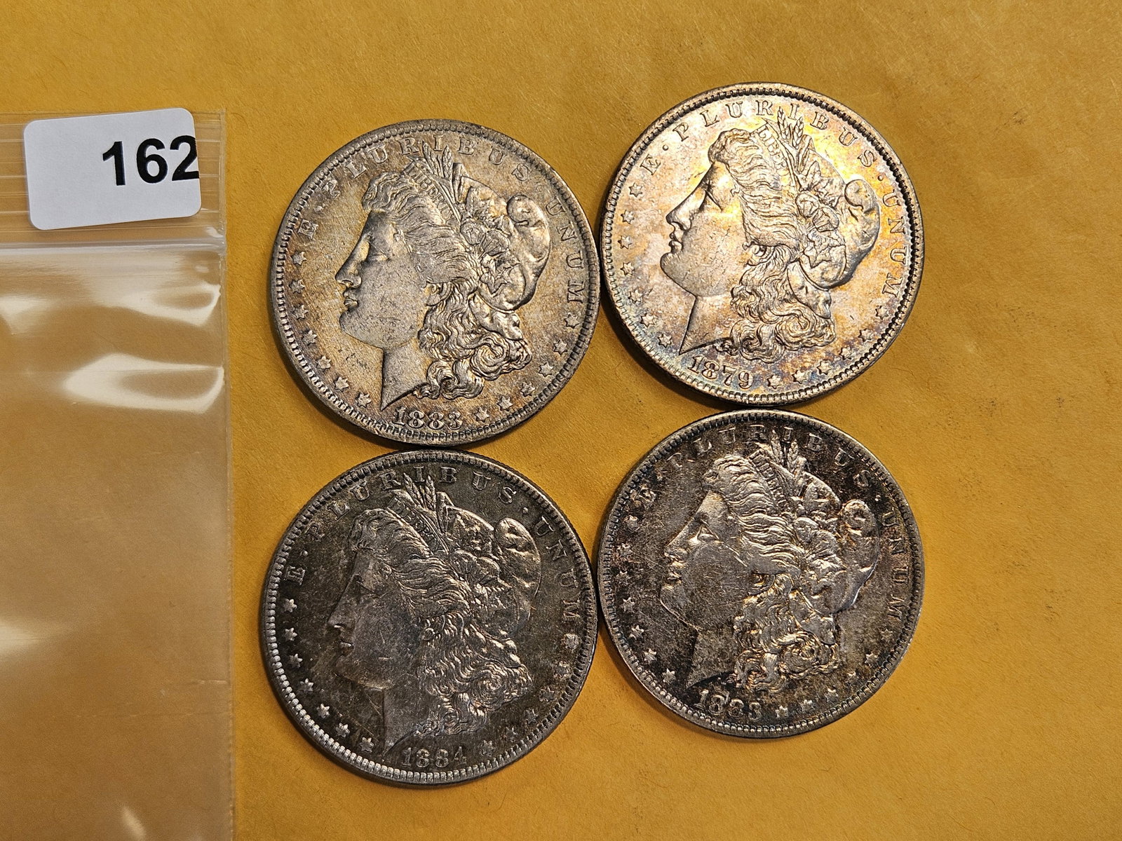 Four mixed Morgan silver Dollars: Mixed dates and grades