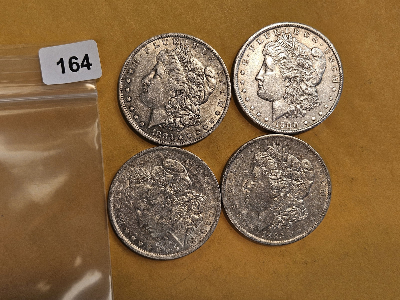 Four mixed Morgan silver Dollars: Mixed dates and grades