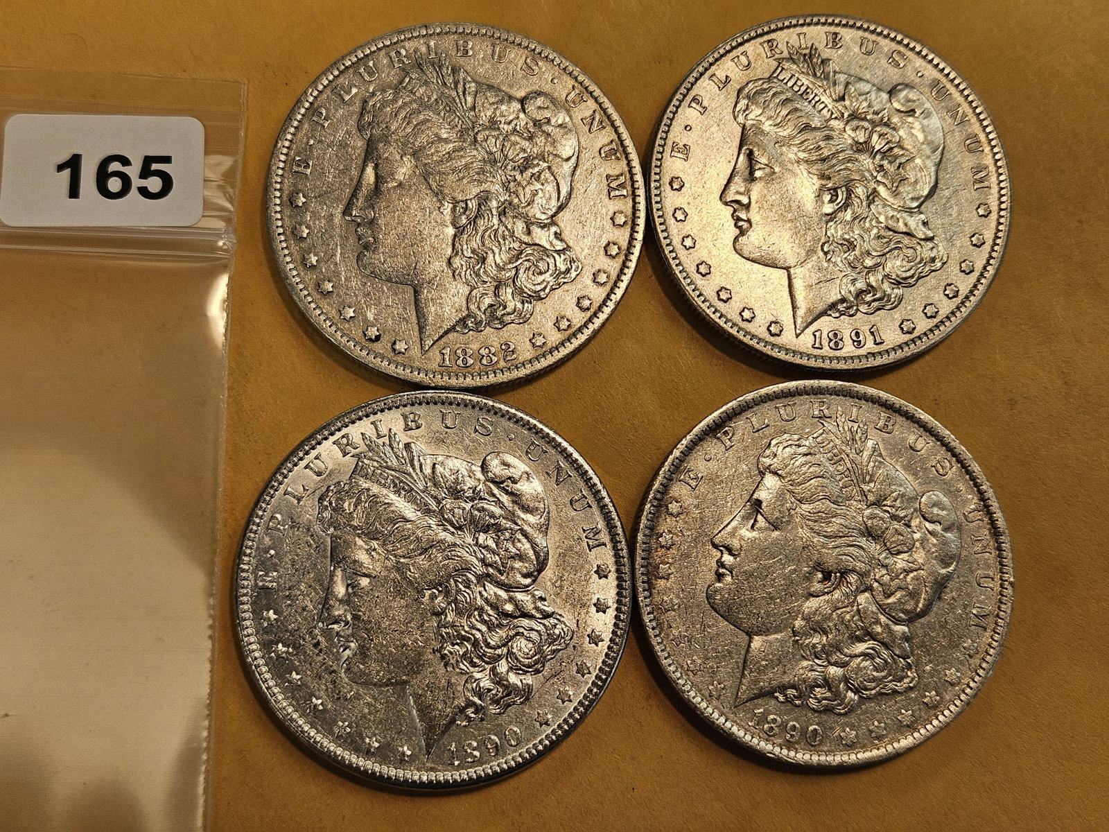 Four mixed Morgan silver Dollars: Mixed dates and grades