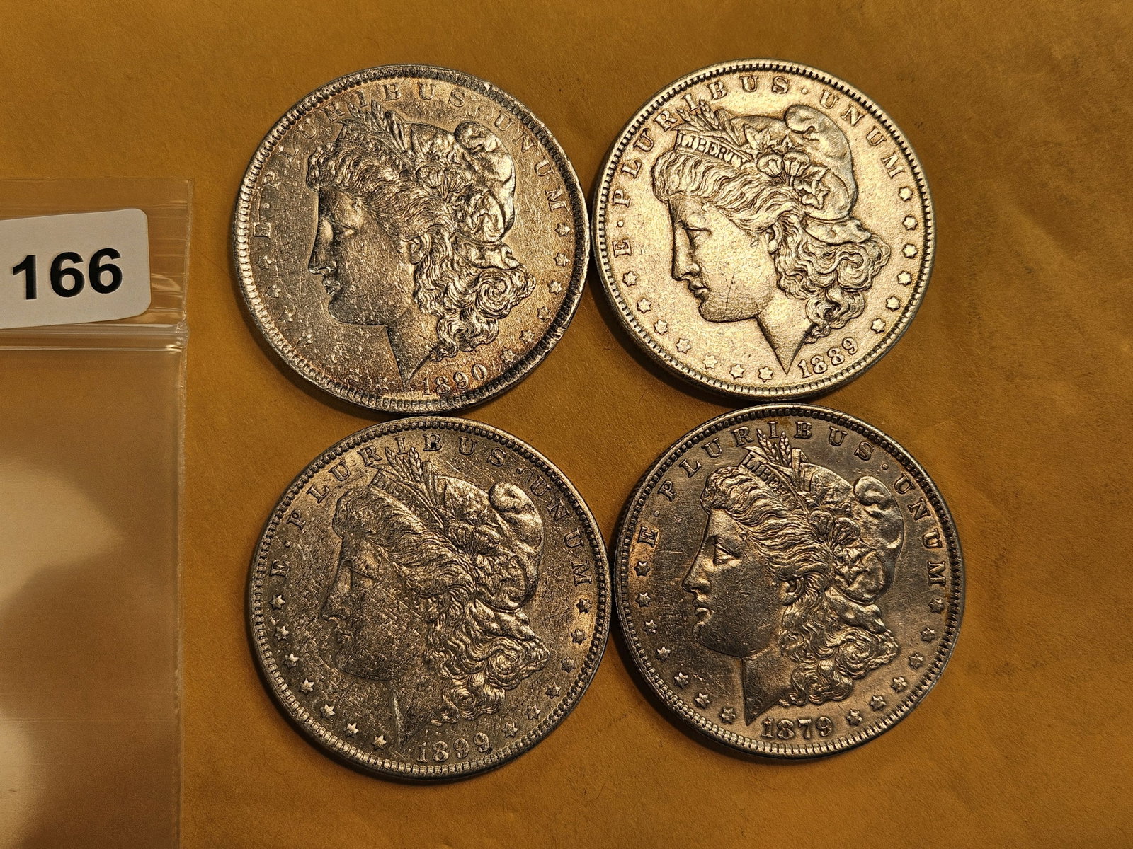 Four mixed Morgan silver Dollars: Mixed dates and grades