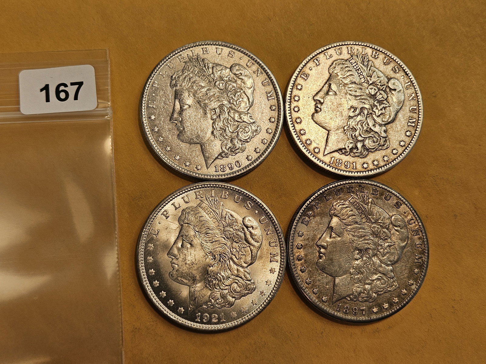 Four mixed Morgan silver Dollars: Mixed dates and grades