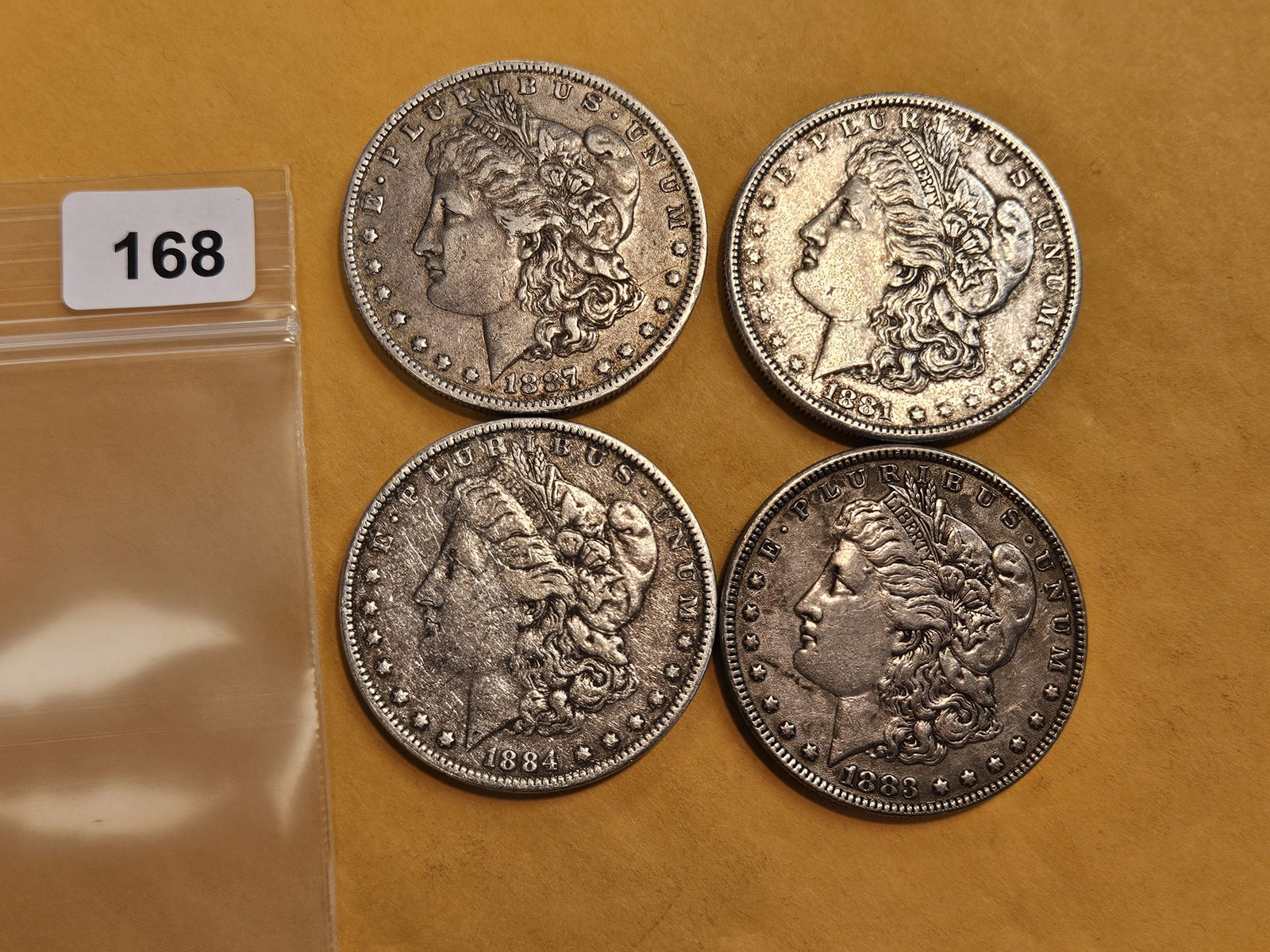 Four mixed Morgan silver Dollars: Mixed dates and grades