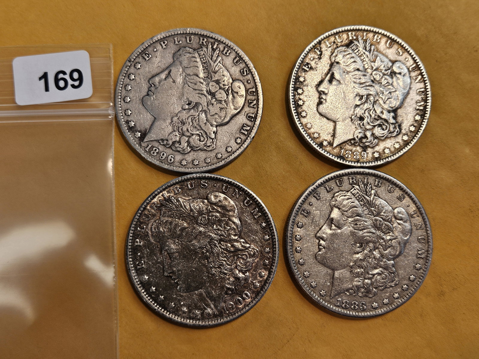 Four mixed Morgan silver Dollars: Mixed dates and grades