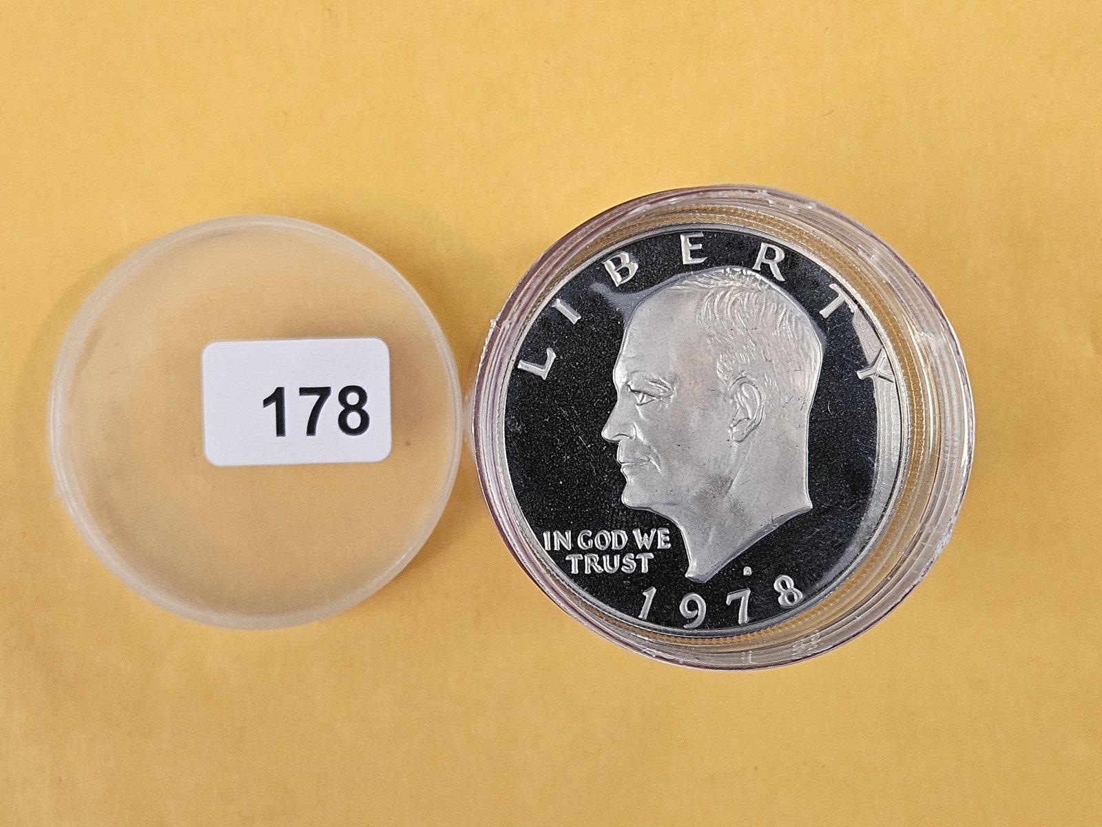 Roll of fourteen Eisenhower Dollars: Unchecked by us. Top one is Proof. Two at the bottom show Silver on the rims