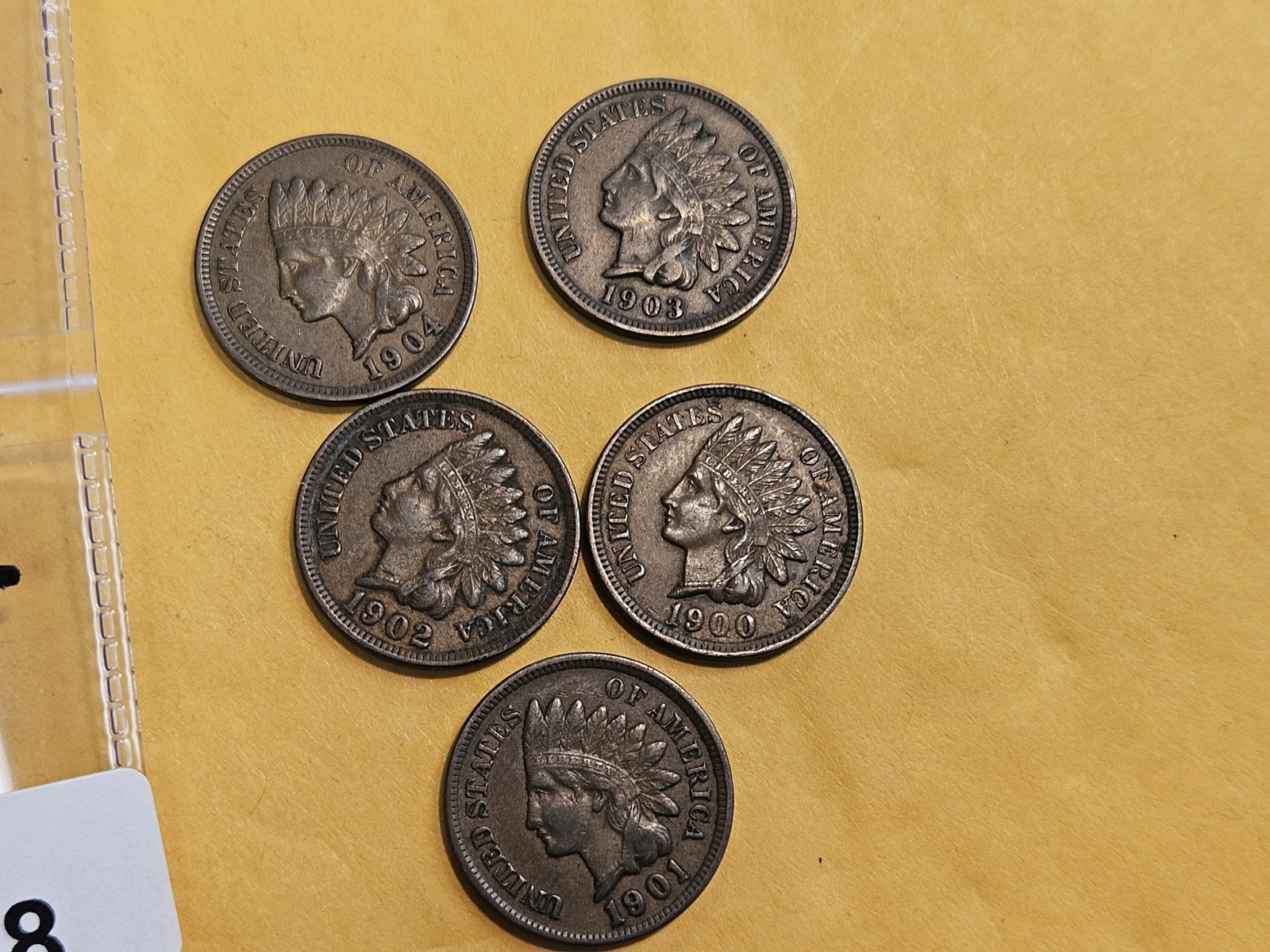 Five Indian Cents in Extra Fine plus to About Uncirculated: 1900, 1901, 1902, 1903, and 1904