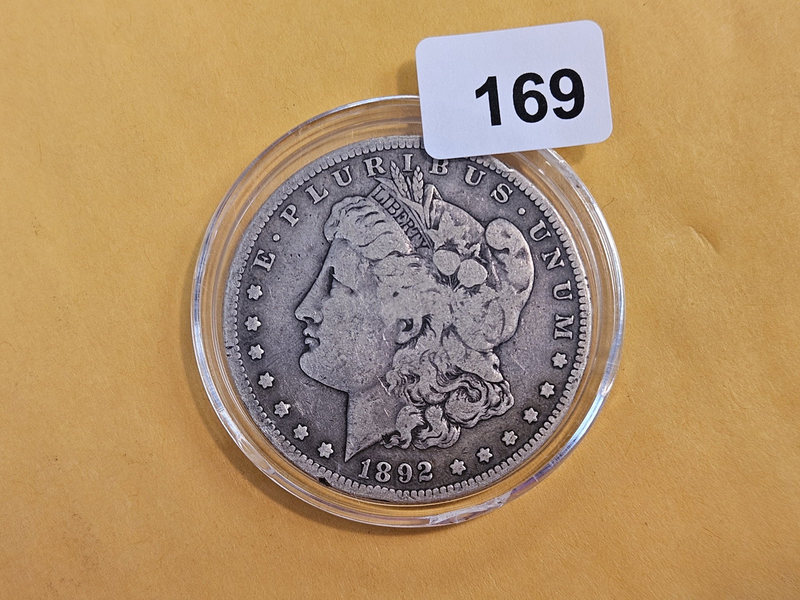 1892 Morgan silver Dollar: There are 3 little hits right where a mint mark should be