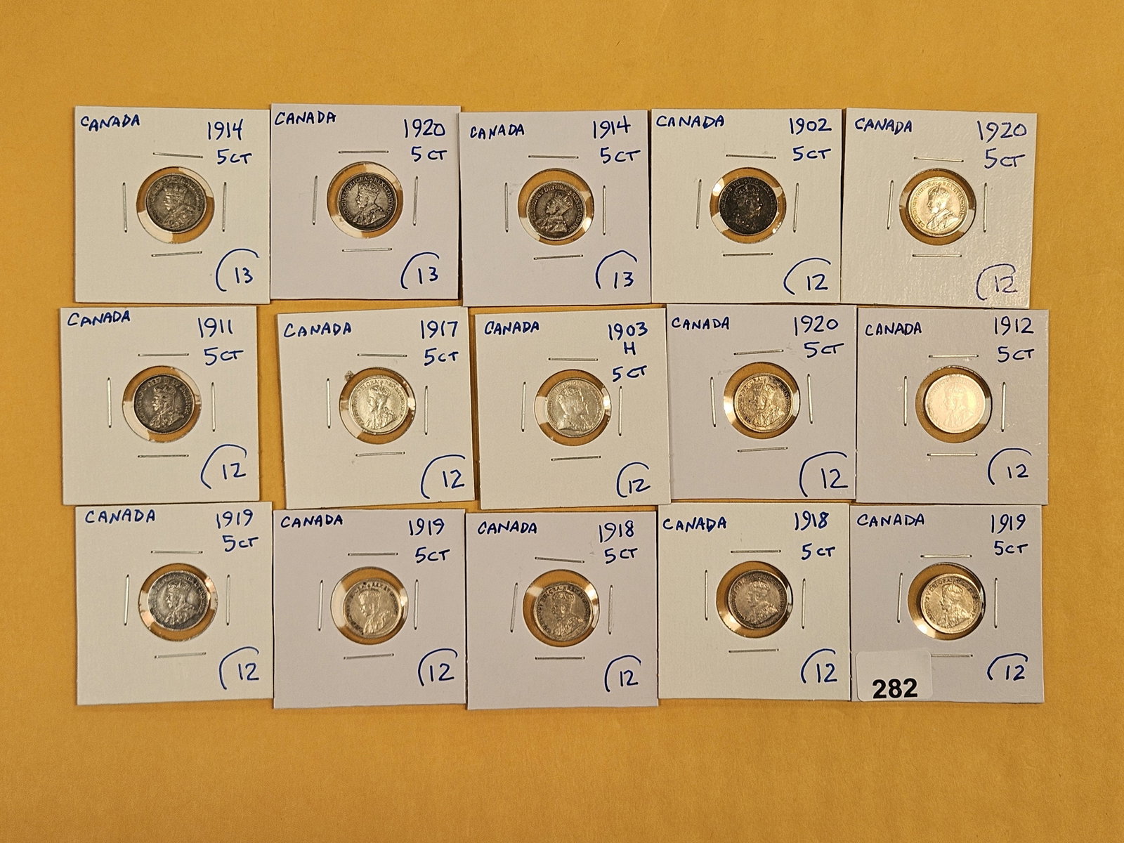 Fifteen mixed, silver, Canadian 5 cent coins: Mixed dates and grades.