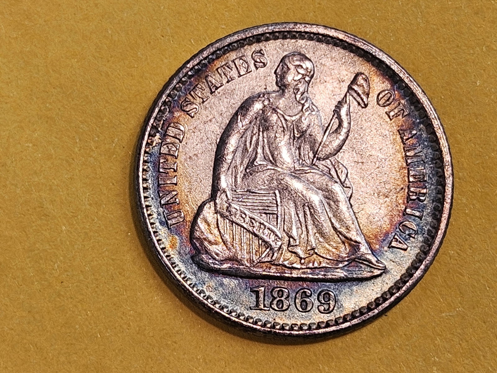 Brilliant About Uncirculated Plus 1869 Seated Liberty silver Half-Dime: Gorgeous eye appeal! Lovely arc of color!