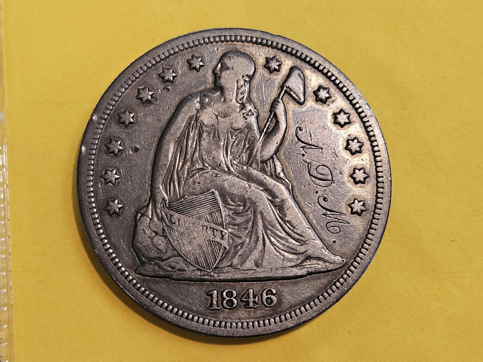 * 1846 Seated Liberty silver Dollar in Very Fine plus - details: Solid coin, just has initials in the obverse