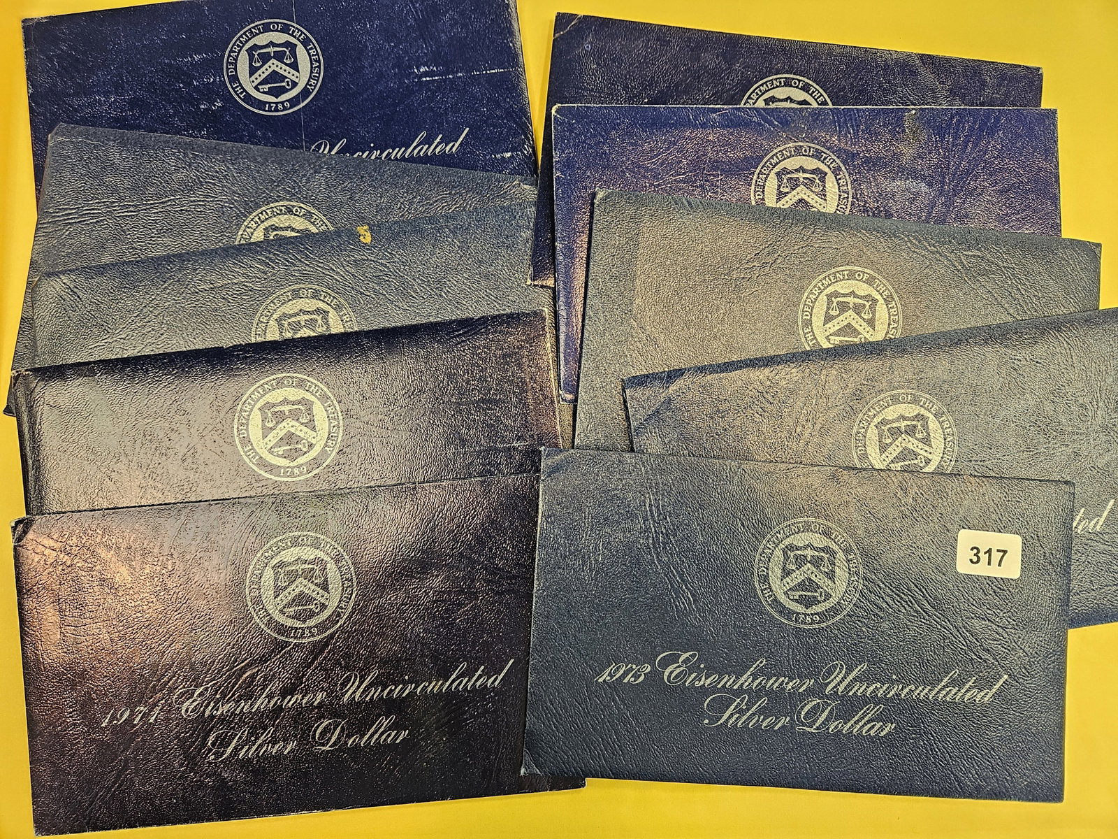 Ten Uncirculated Eisenhower Silver Dollars: Blue Ikes. In OGP