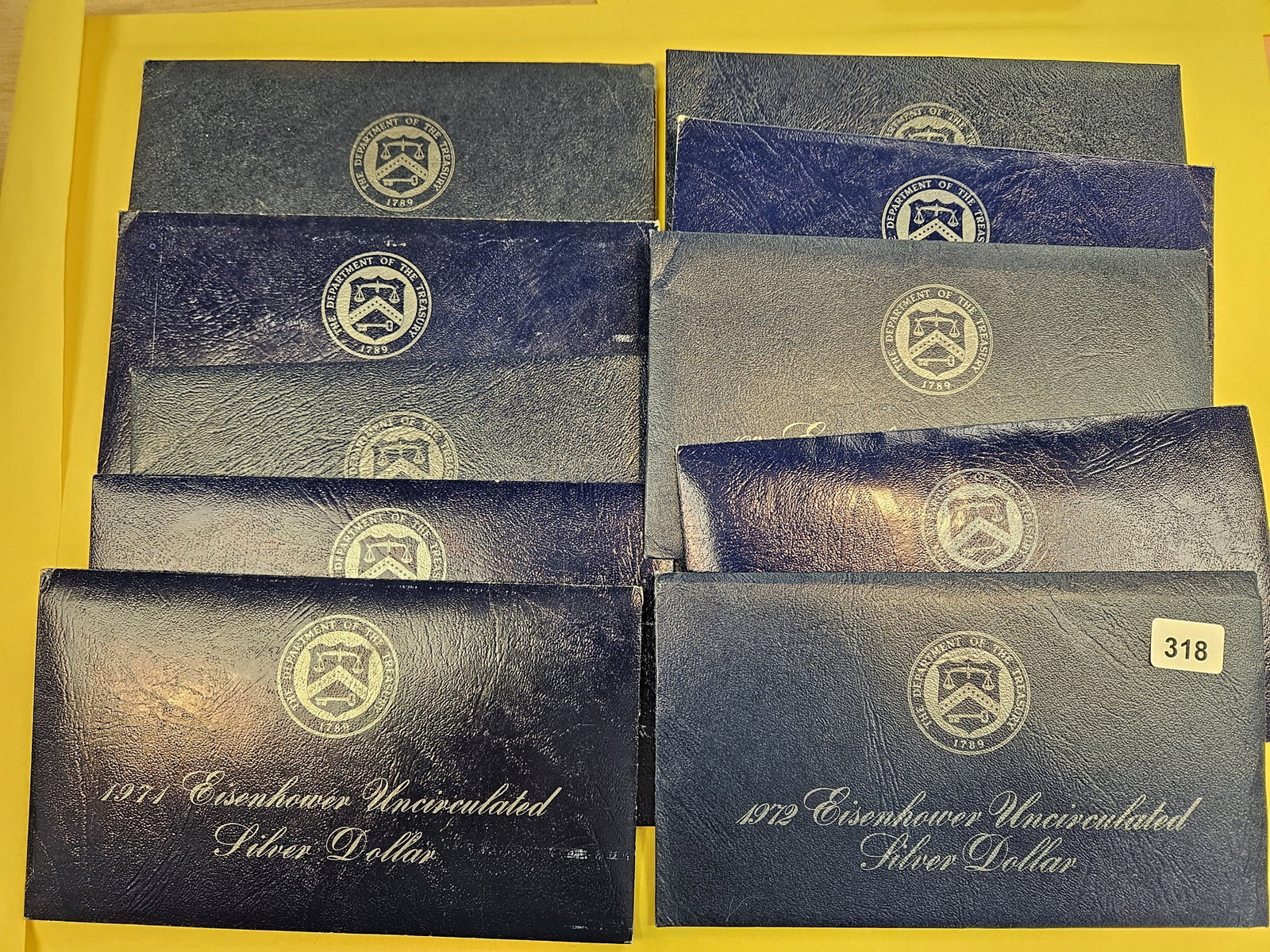 Ten Uncirculated Eisenhower Silver Dollars: Blue Ikes. In OGP